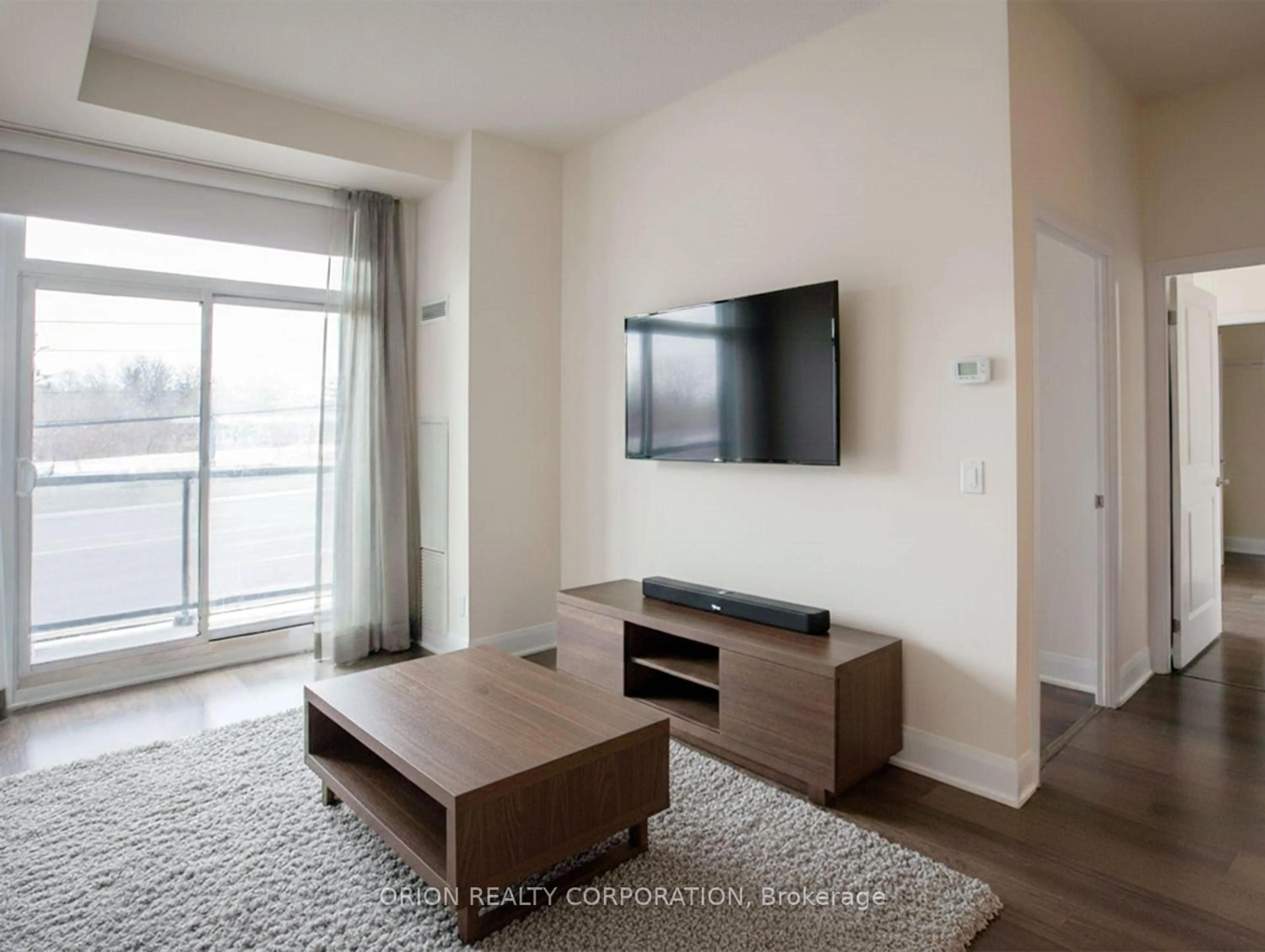 Living room with furniture, wood/laminate floor for 4700 Highway 7 Rd #215, Vaughan Ontario L4L 0B4