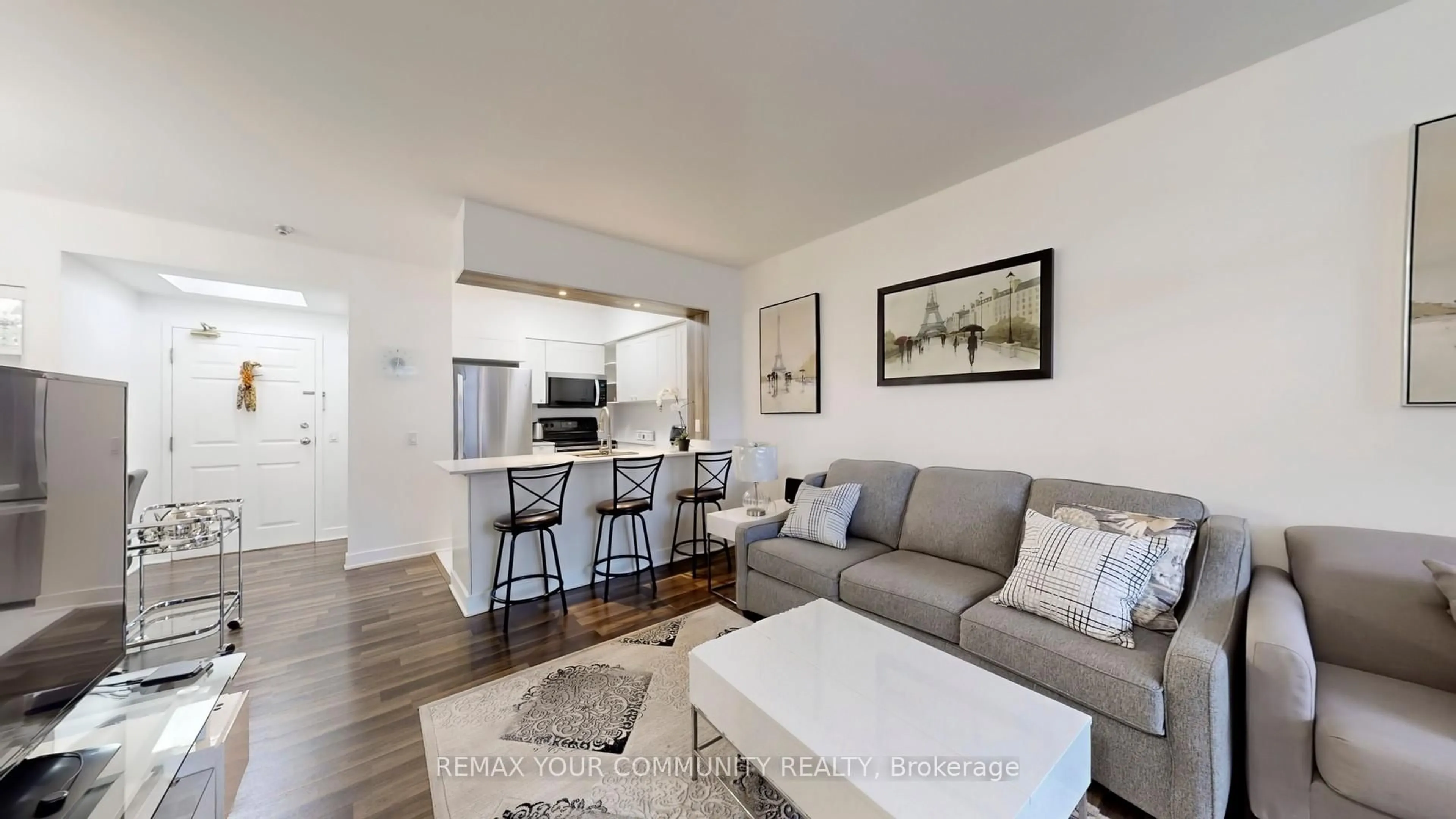 Living room with furniture, wood/laminate floor for 7398 Yonge St #111, Vaughan Ontario L4J 8J2