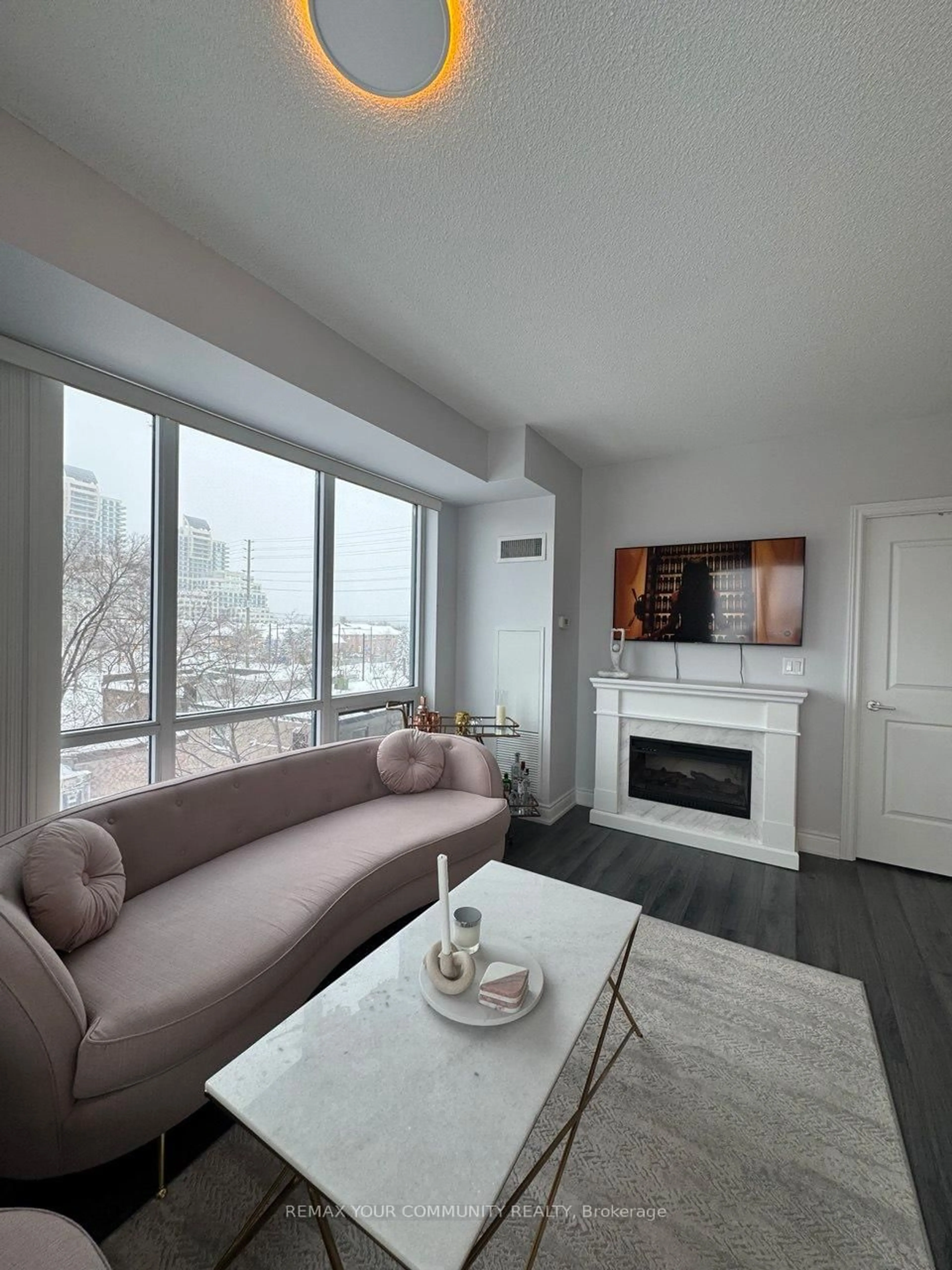 Living room with furniture, wood/laminate floor for 9090 Yonge St #302B, Richmond Hill Ontario L4C 0Z1