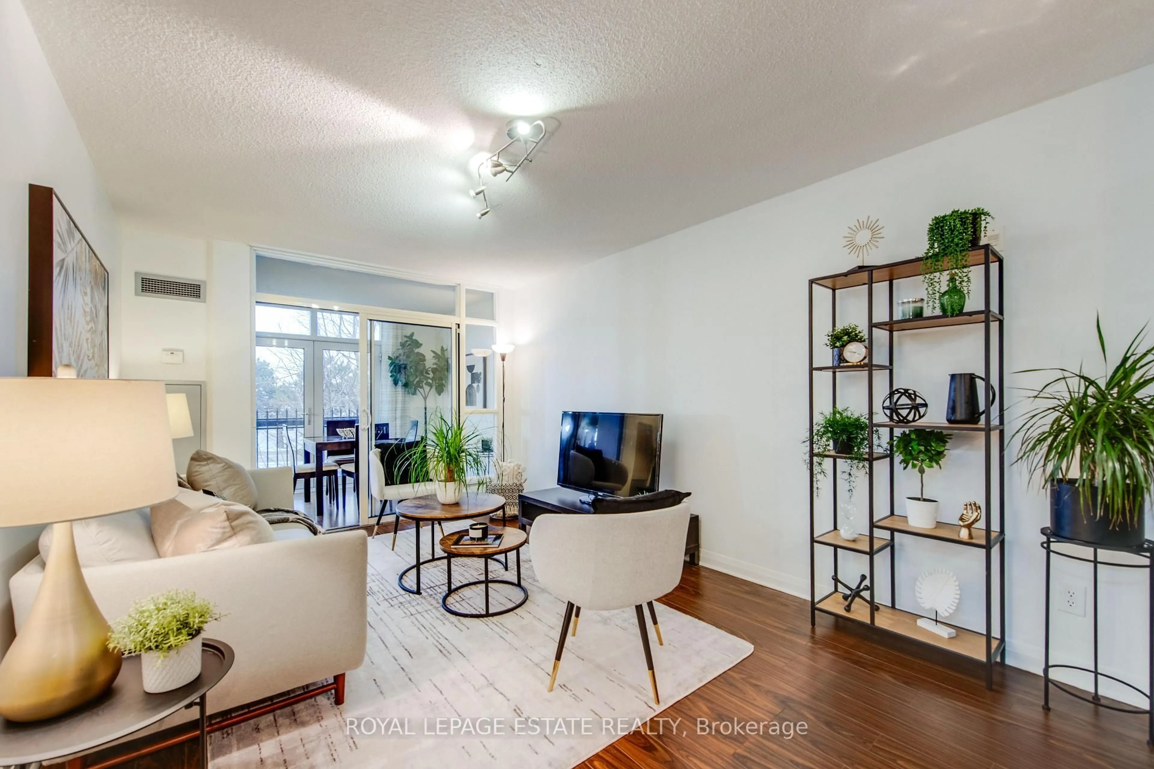 Living room with furniture, wood/laminate floor for 7363 Kennedy Rd #213, Markham Ontario L3R 1G8