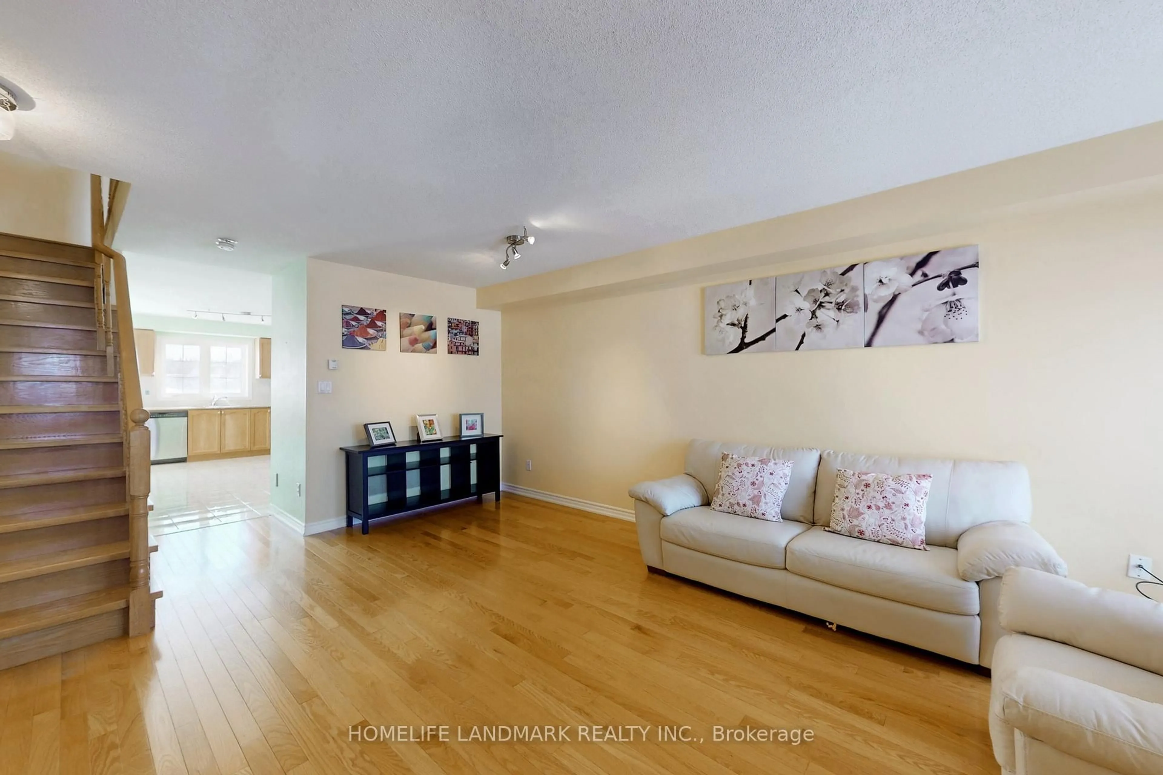 Living room with furniture, wood/laminate floor for 323 Caboto Tr, Markham Ontario L3R 1L2