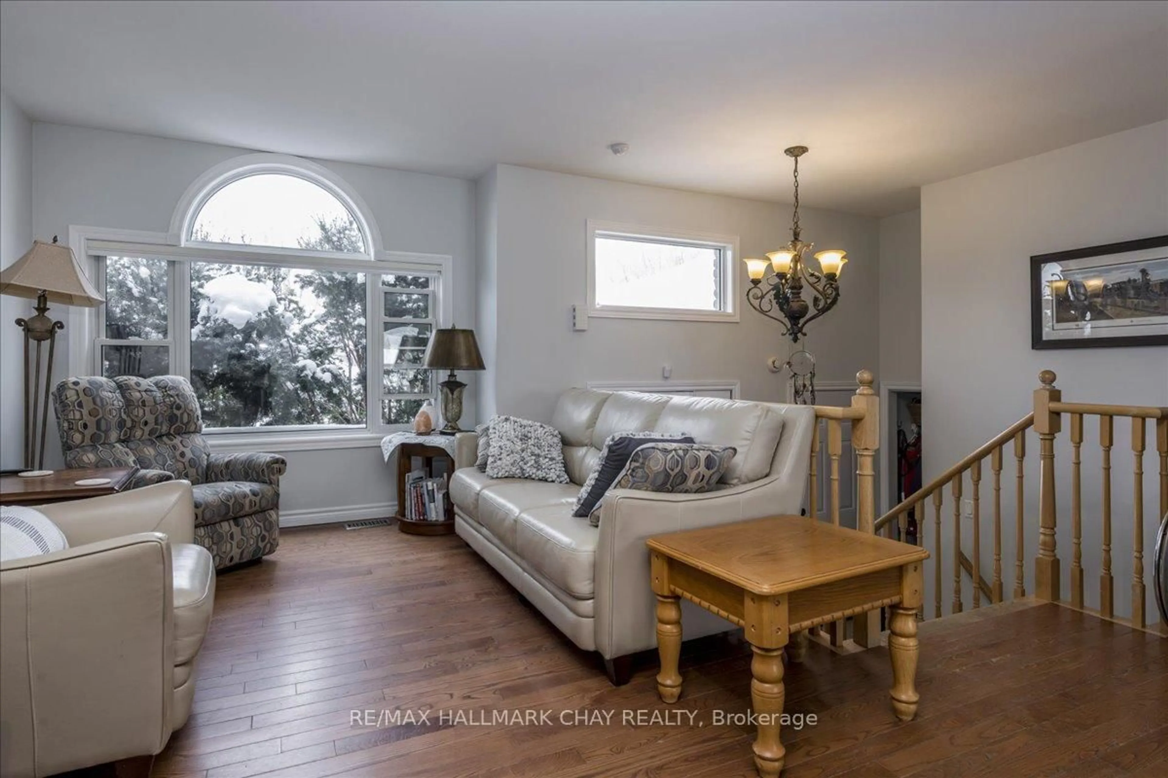 Living room with furniture, wood/laminate floor for 2 Mancini Dr, Essa Ontario L3W 0A6