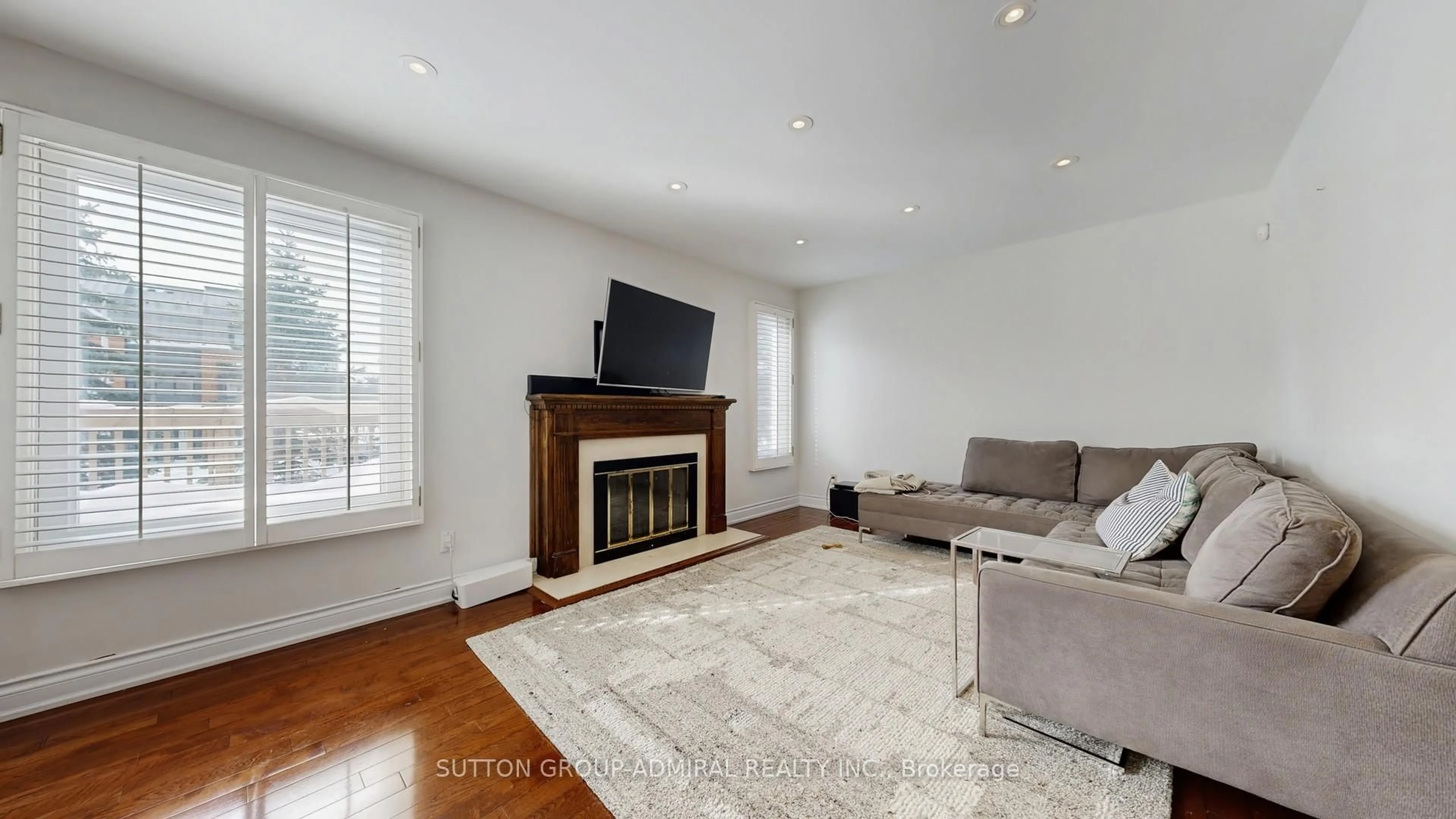 Living room with furniture, wood/laminate floor for 239 Rose Green Dr, Vaughan Ontario L4J 4R3