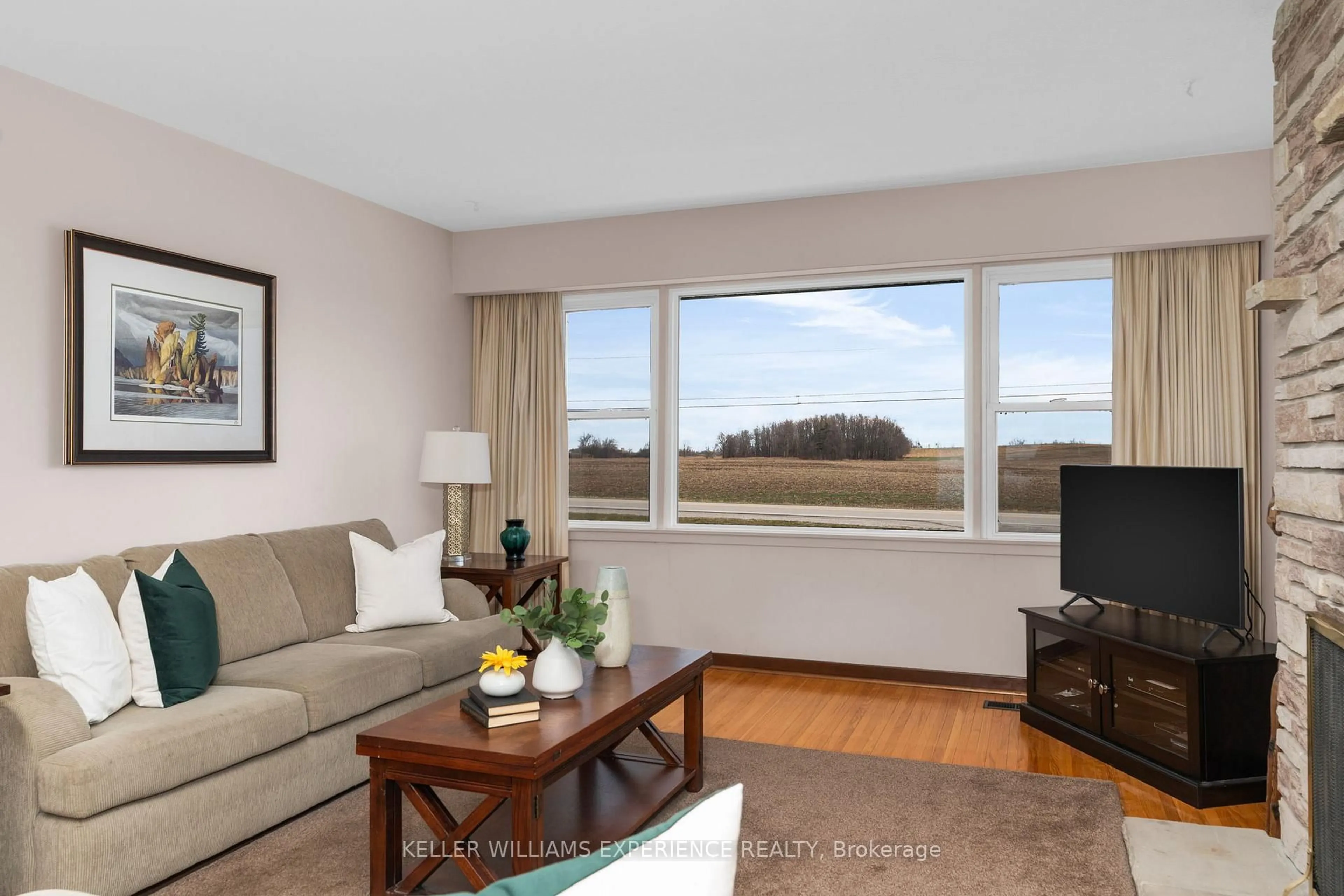 Living room with furniture, wood/laminate floor for 5628 County Rd 27 Rd, Essa Ontario L0L 1L0