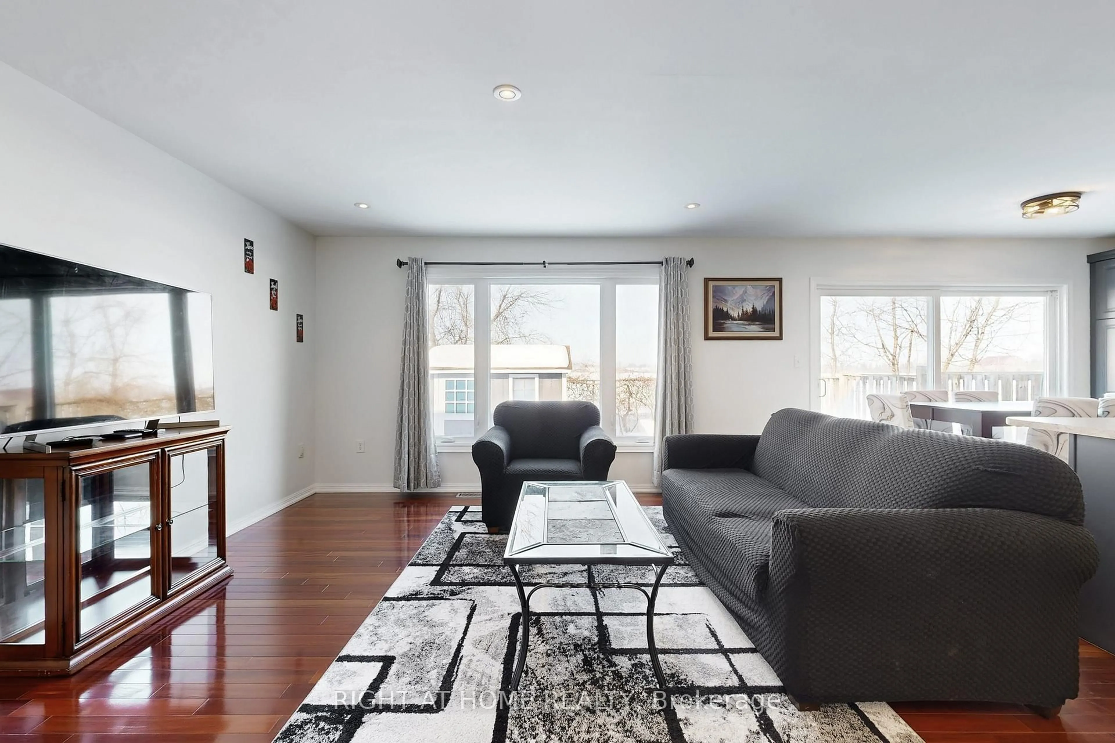 Living room with furniture, wood/laminate floor for 78 John W Taylor Ave, New Tecumseth Ontario L9R 0C9