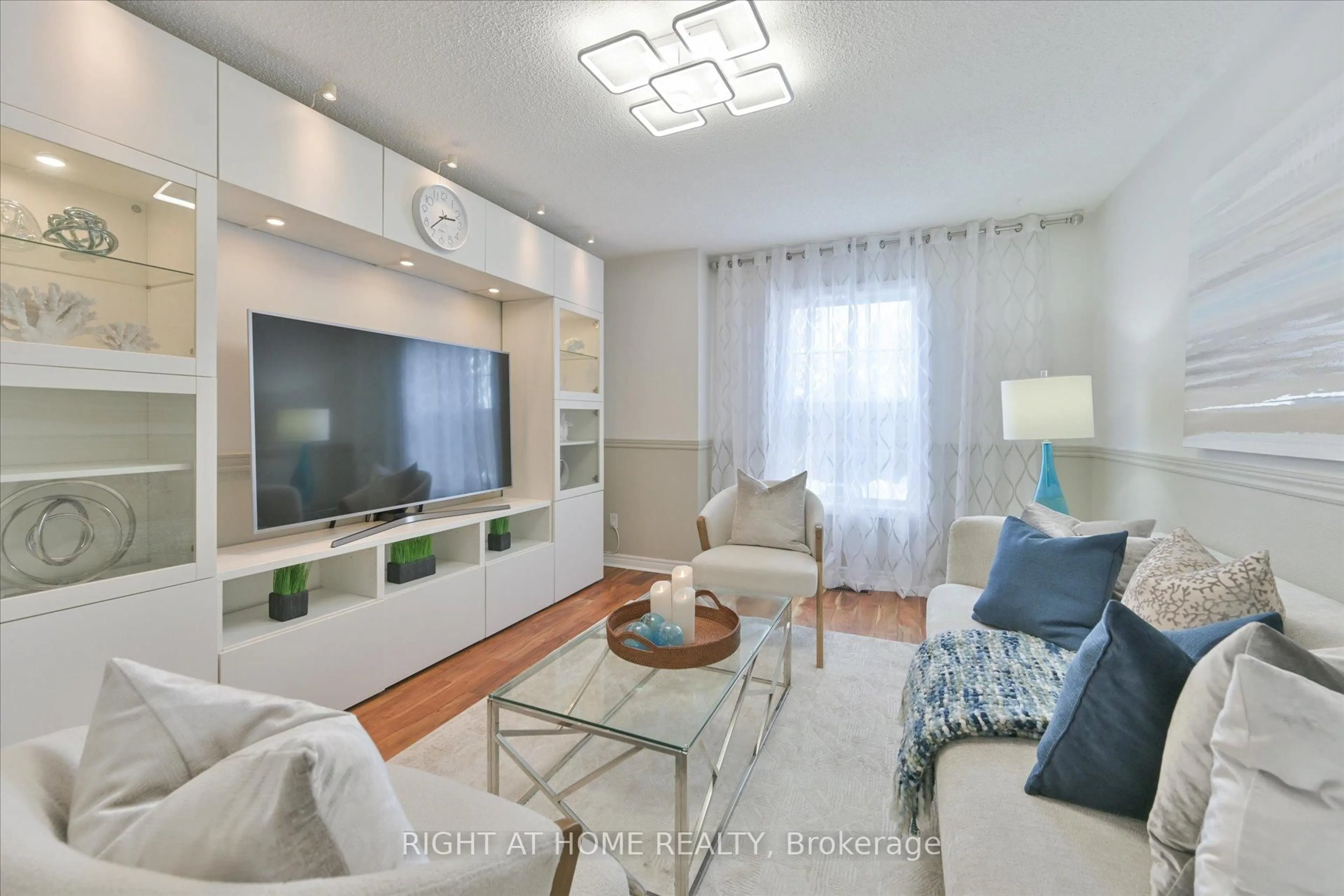 Living room with furniture, wood/laminate floor for 61 Milloy Pl, Aurora Ontario L4G 7L2