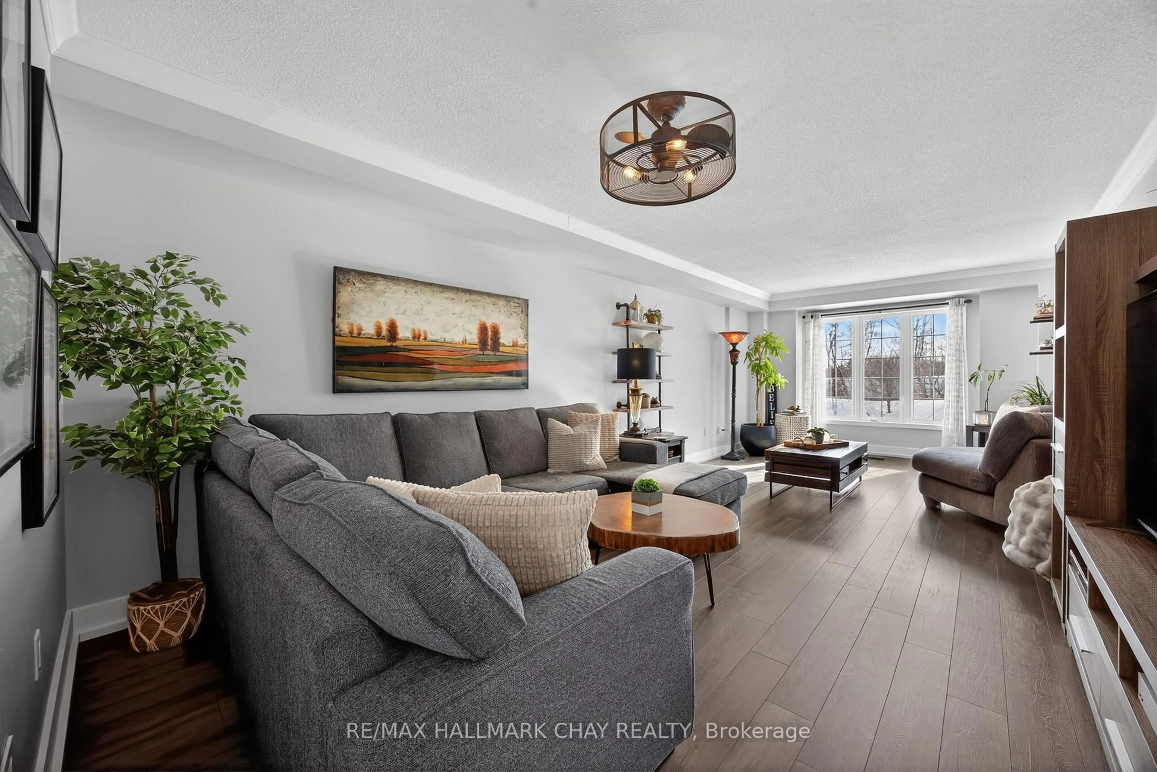 Living room with furniture, wood/laminate floor for 1412 Forest St, Innisfil Ontario L9S 4Y4