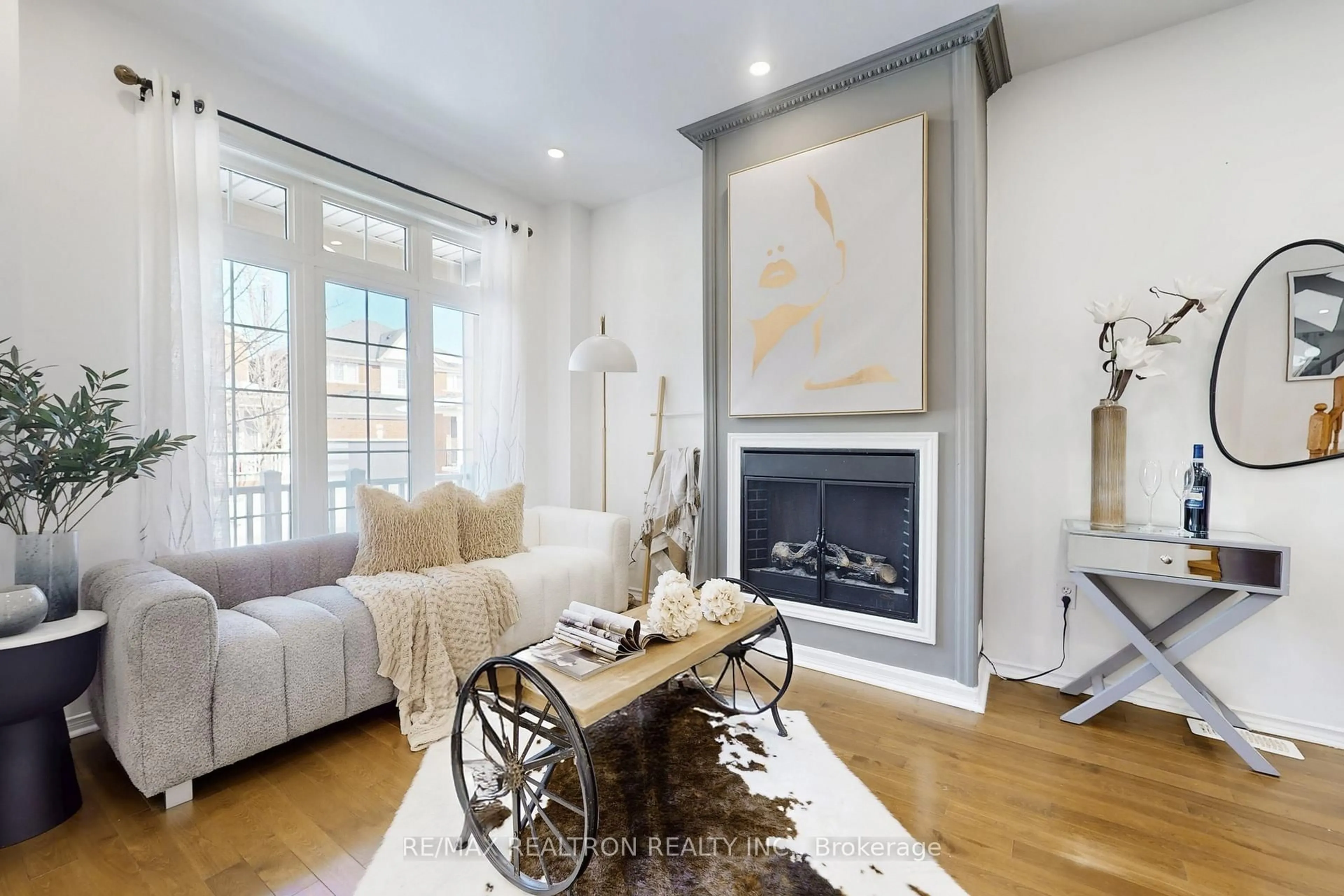 Living room with furniture, wood/laminate floor for 49 Rainbow Valley Cres, Markham Ontario L6E 1Z1