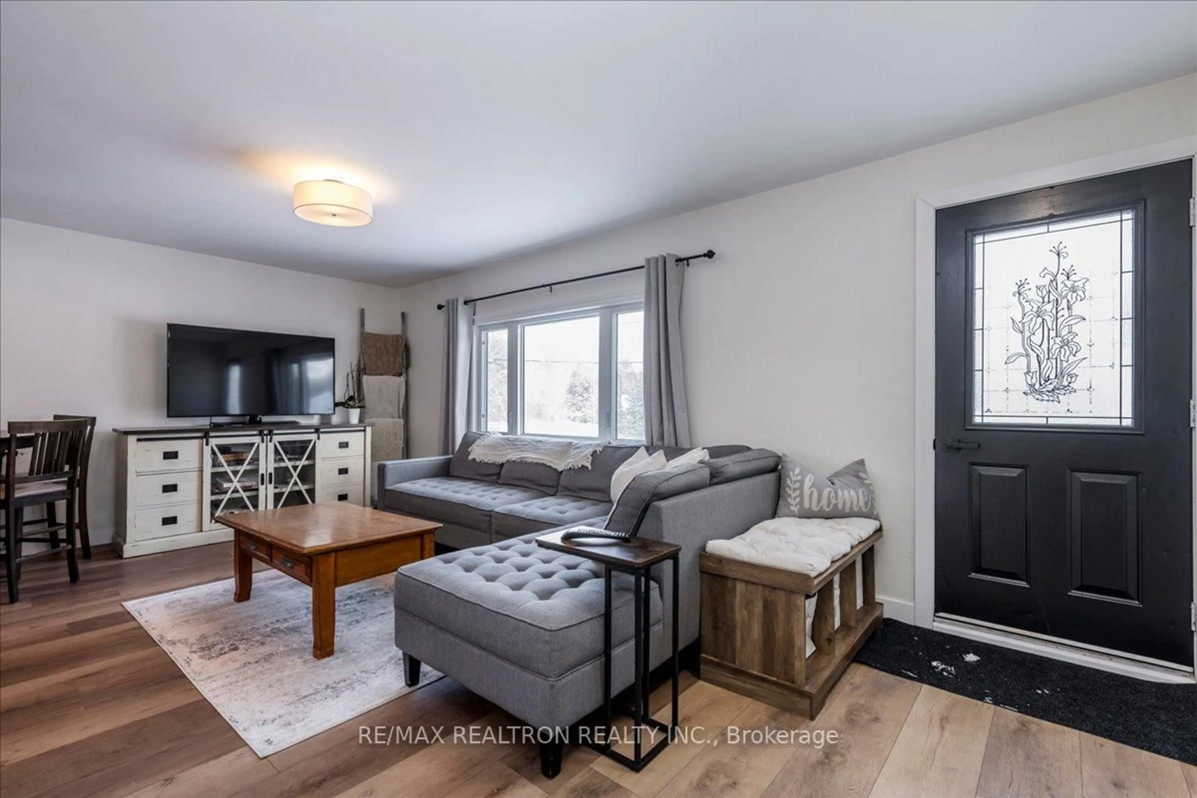 Living room with furniture, wood/laminate floor for 8906 5th Line, Essa Ontario L3W 0C7