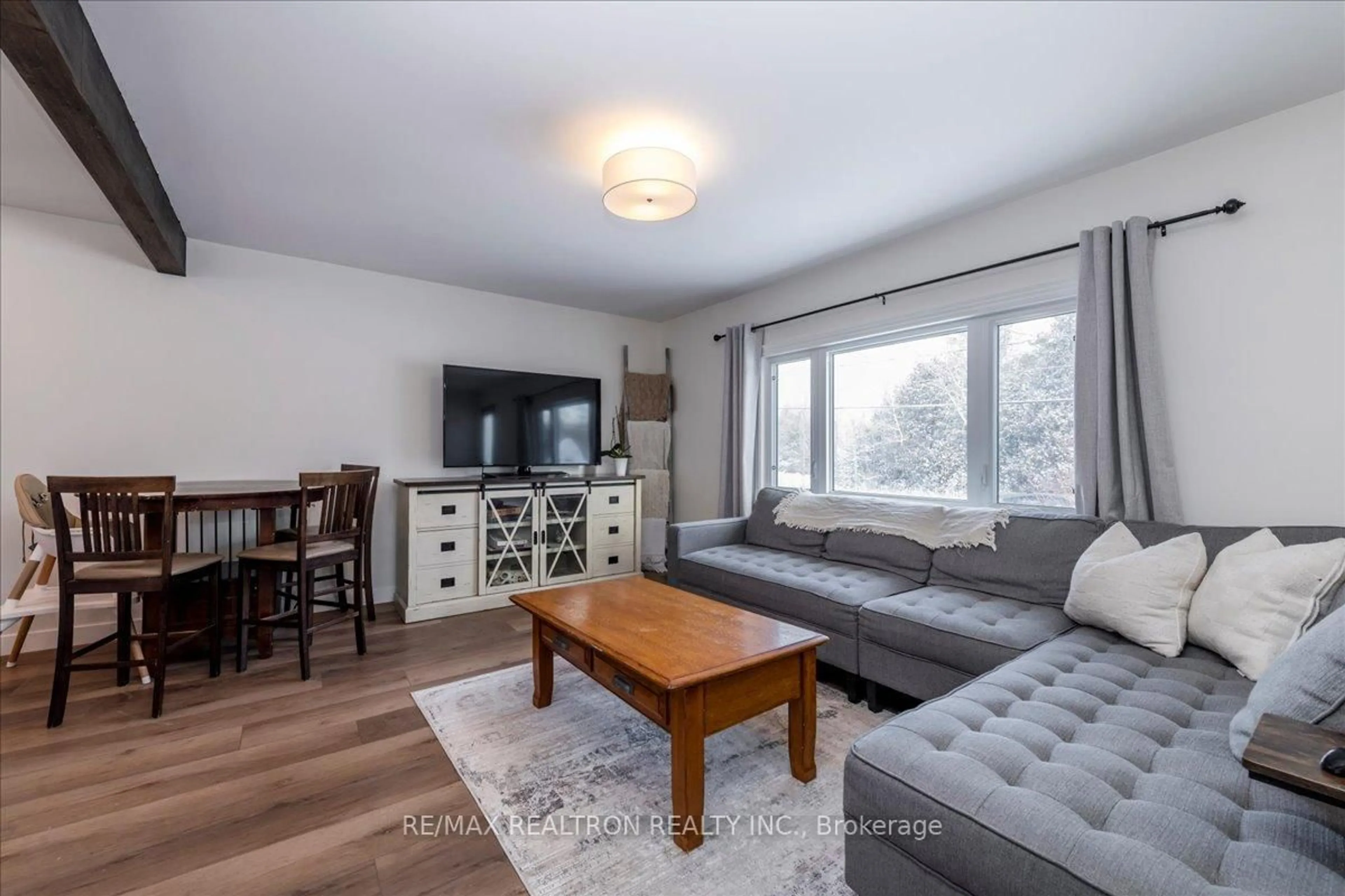 Living room with furniture, wood/laminate floor for 8906 5th Line, Essa Ontario L3W 0C7