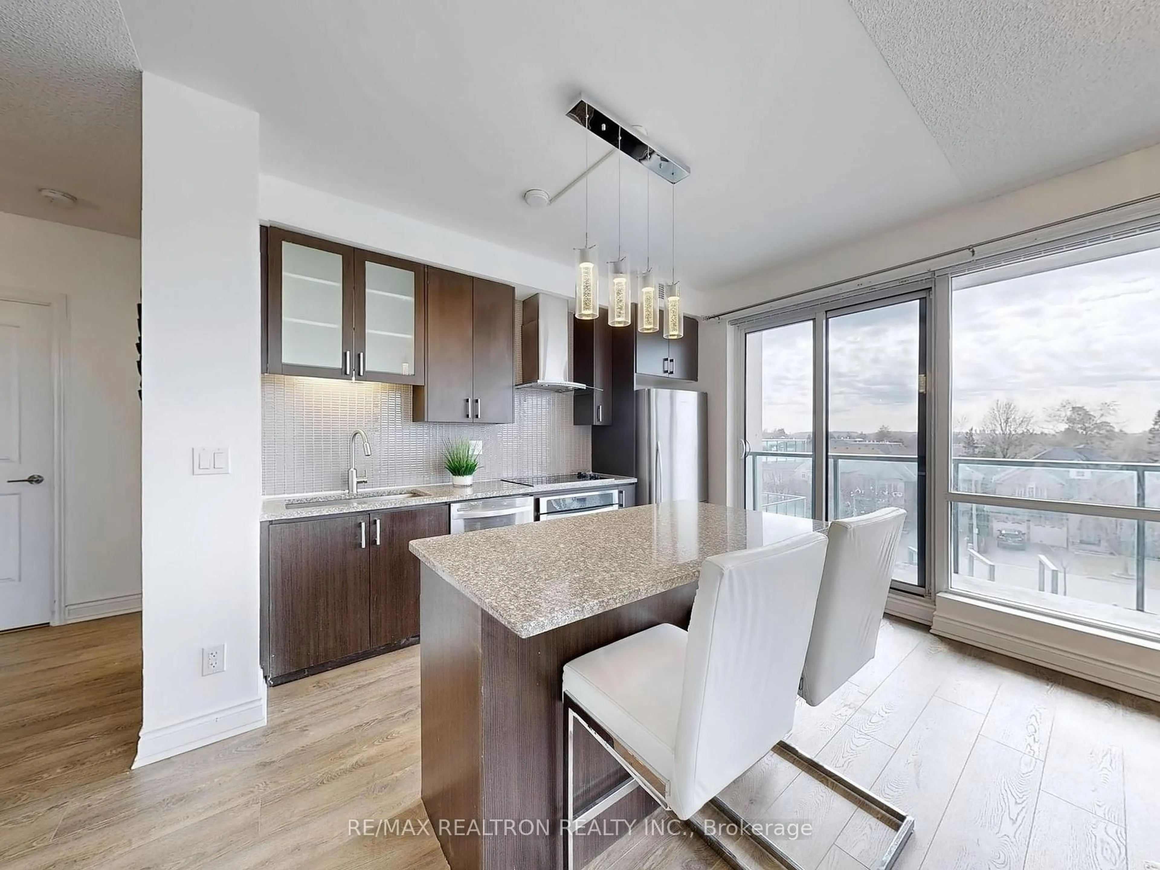 Open concept kitchen, wood/laminate floor for 9088 Yonge St #302A, Richmond Hill Ontario L4C 0Y6