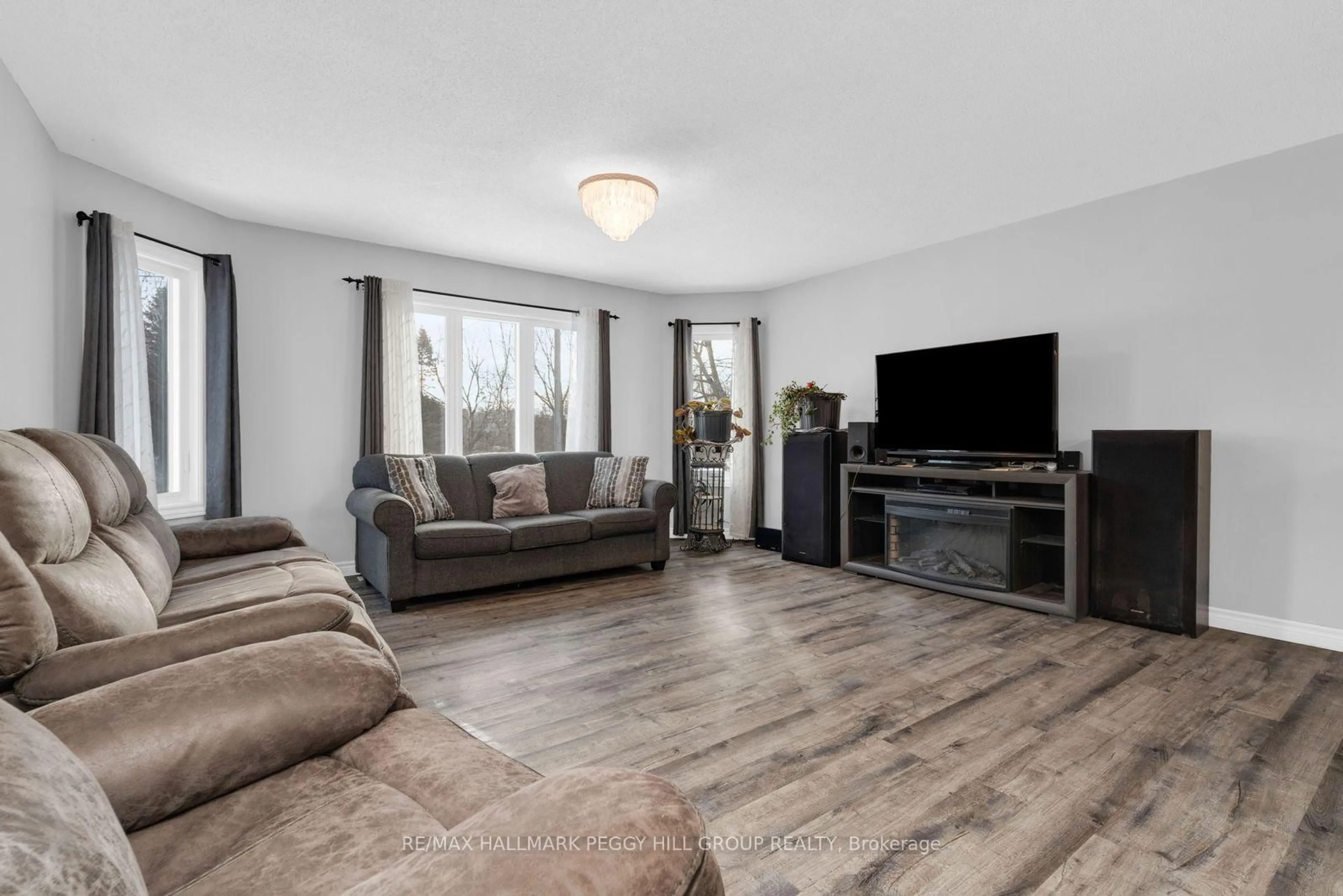 Living room with furniture, wood/laminate floor for 7972 County 13 Rd, Adjala-Tosorontio Ontario L0M 1M0