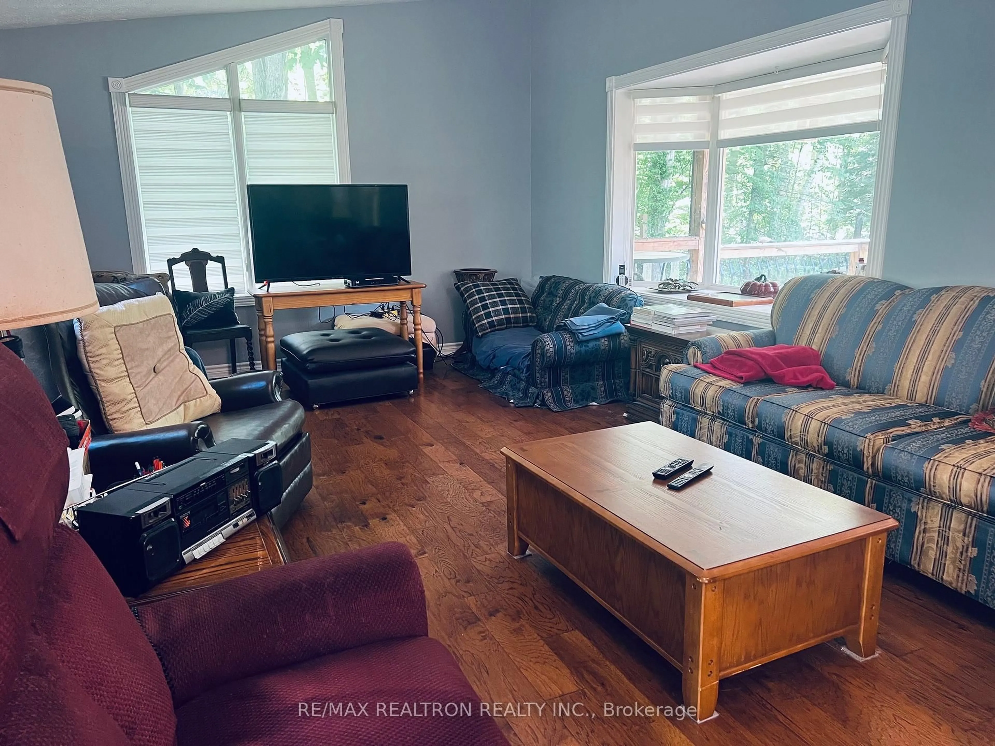 Living room with furniture, wood/laminate floor for 59 Forest Hill Dr, Adjala-Tosorontio Ontario L0M 1J0