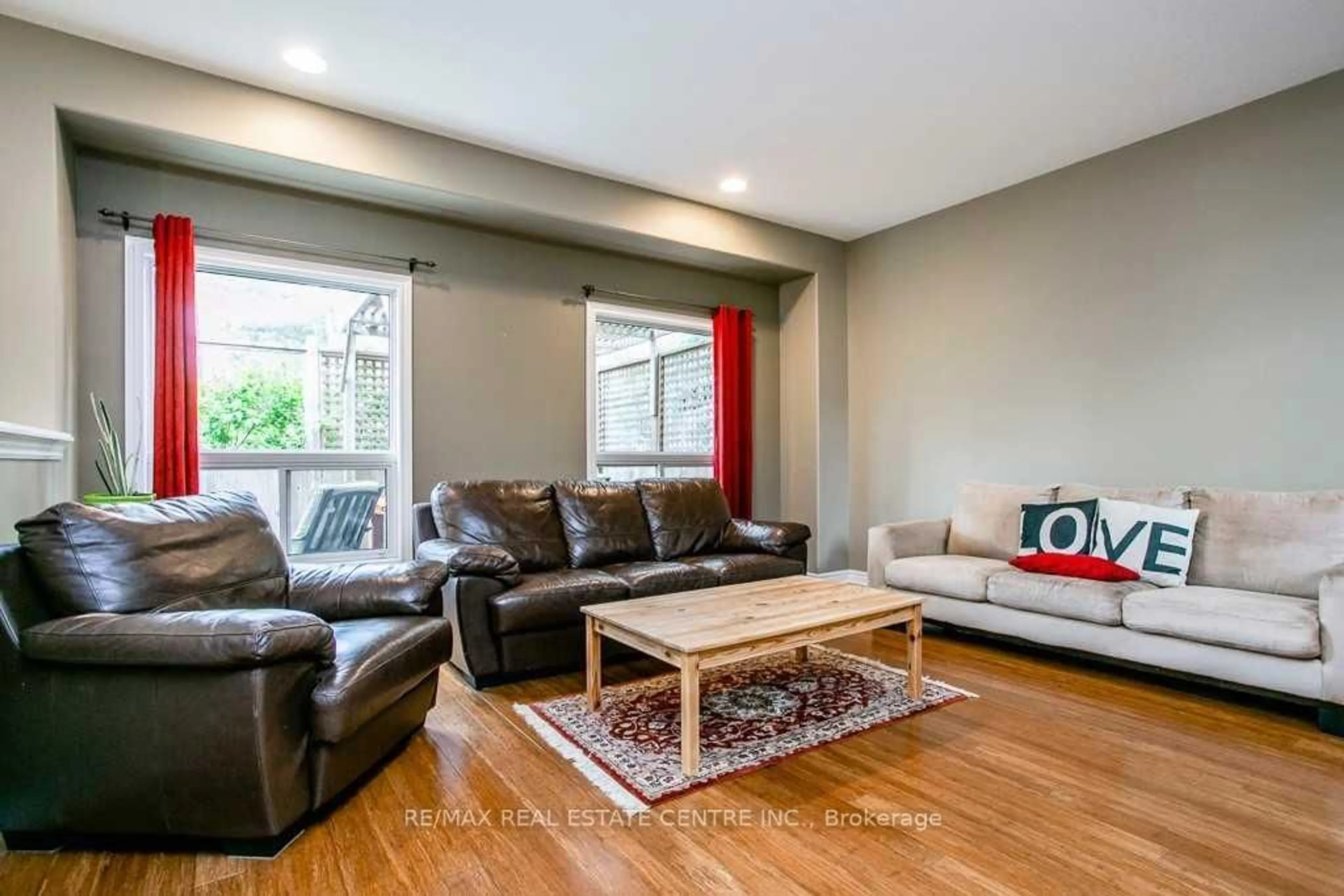 Living room with furniture, wood/laminate floor for 103 Armeda Clow Cres, Essa Ontario L0M 1B2