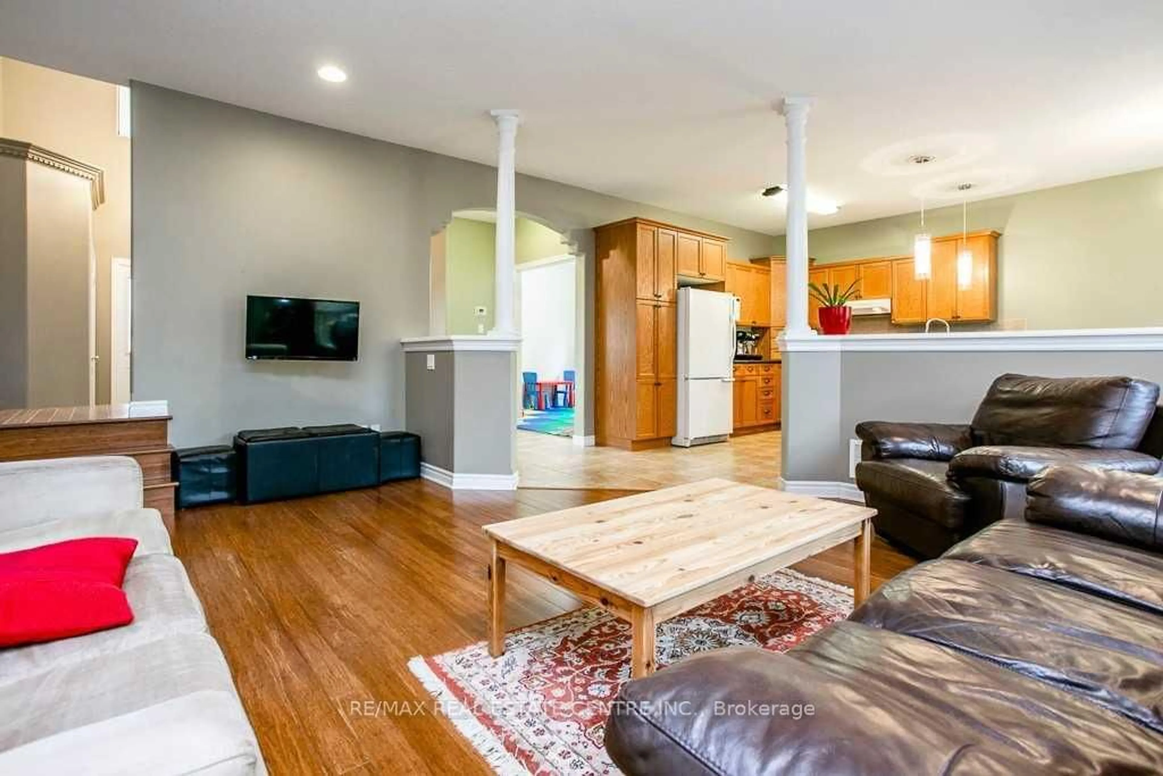 Living room with furniture, wood/laminate floor for 103 Armeda Clow Cres, Essa Ontario L0M 1B2