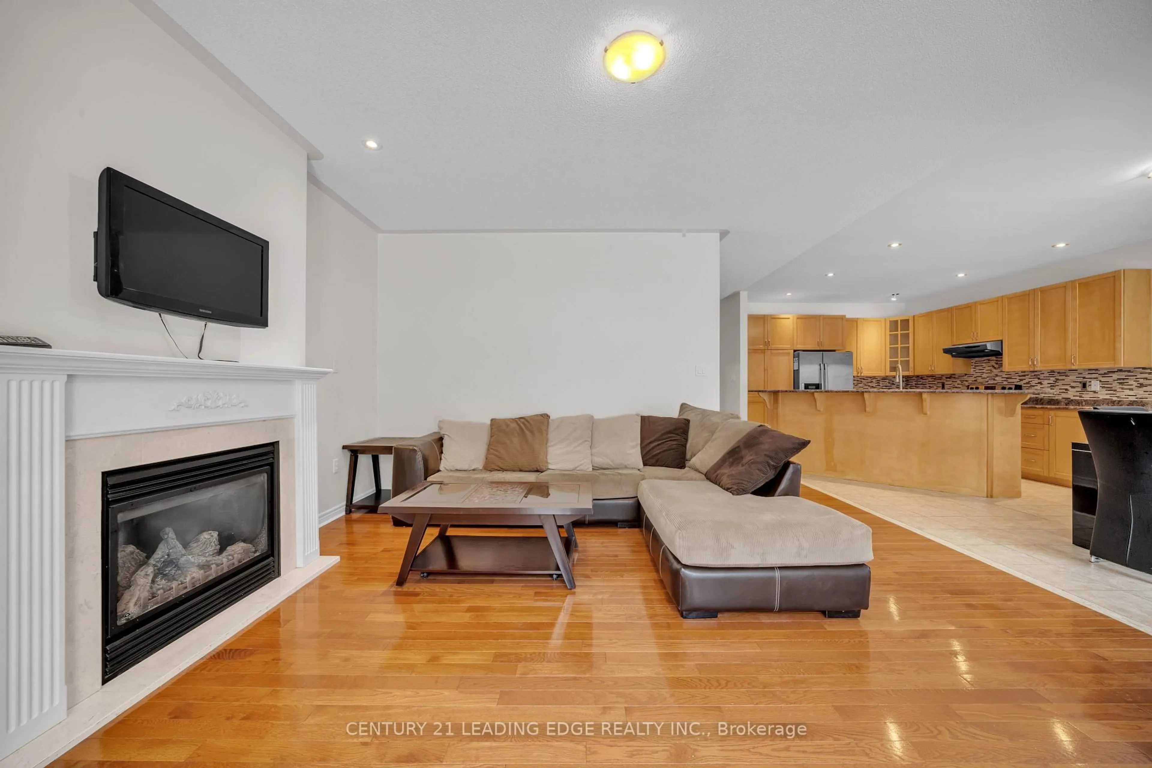 Living room with furniture, wood/laminate floor for 66 Woodbury Cres, Newmarket Ontario L3X 2T2