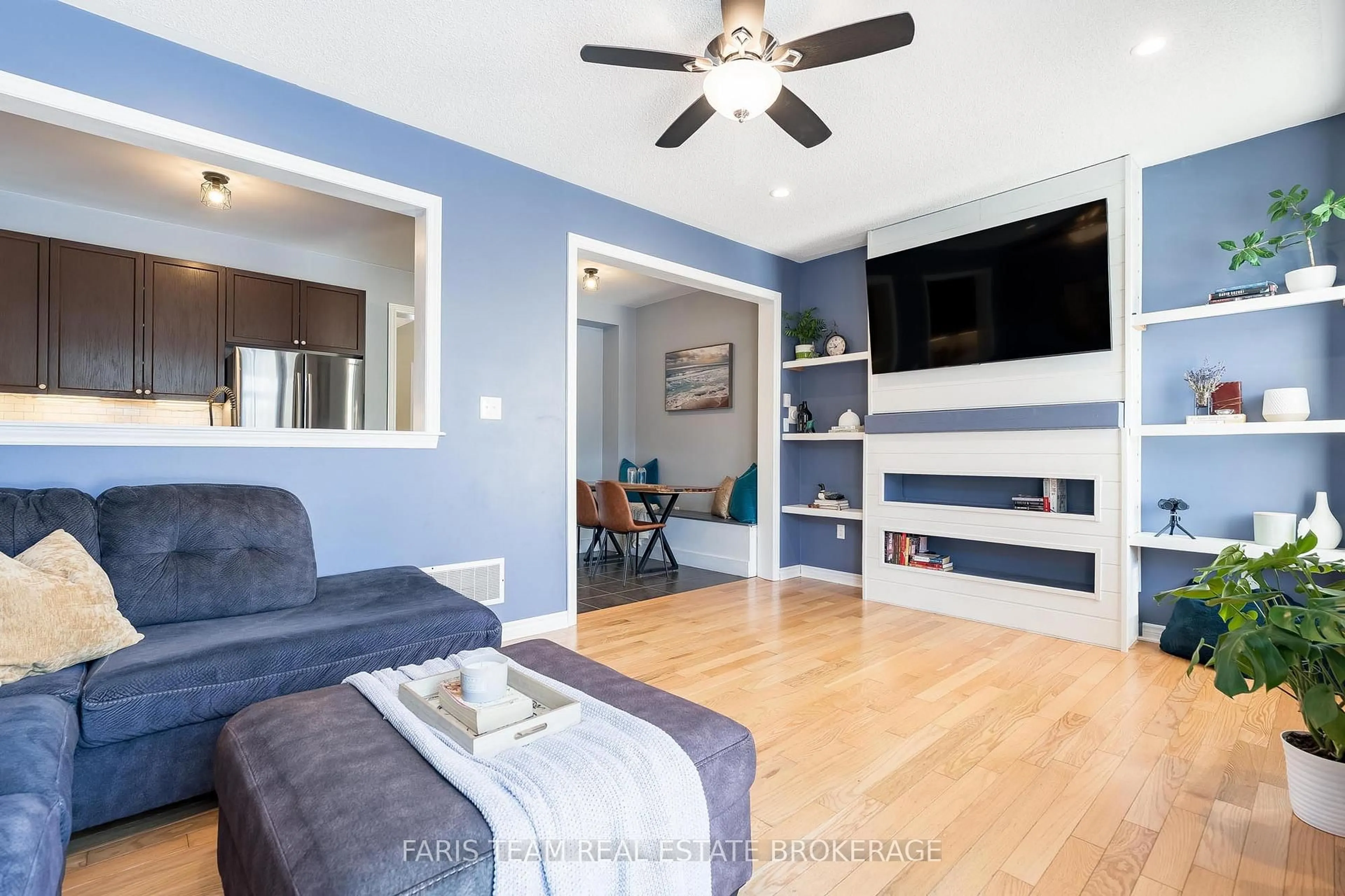 Living room with furniture, wood/laminate floor for 80 Blanchard Cres, Essa Ontario L3W 0M9