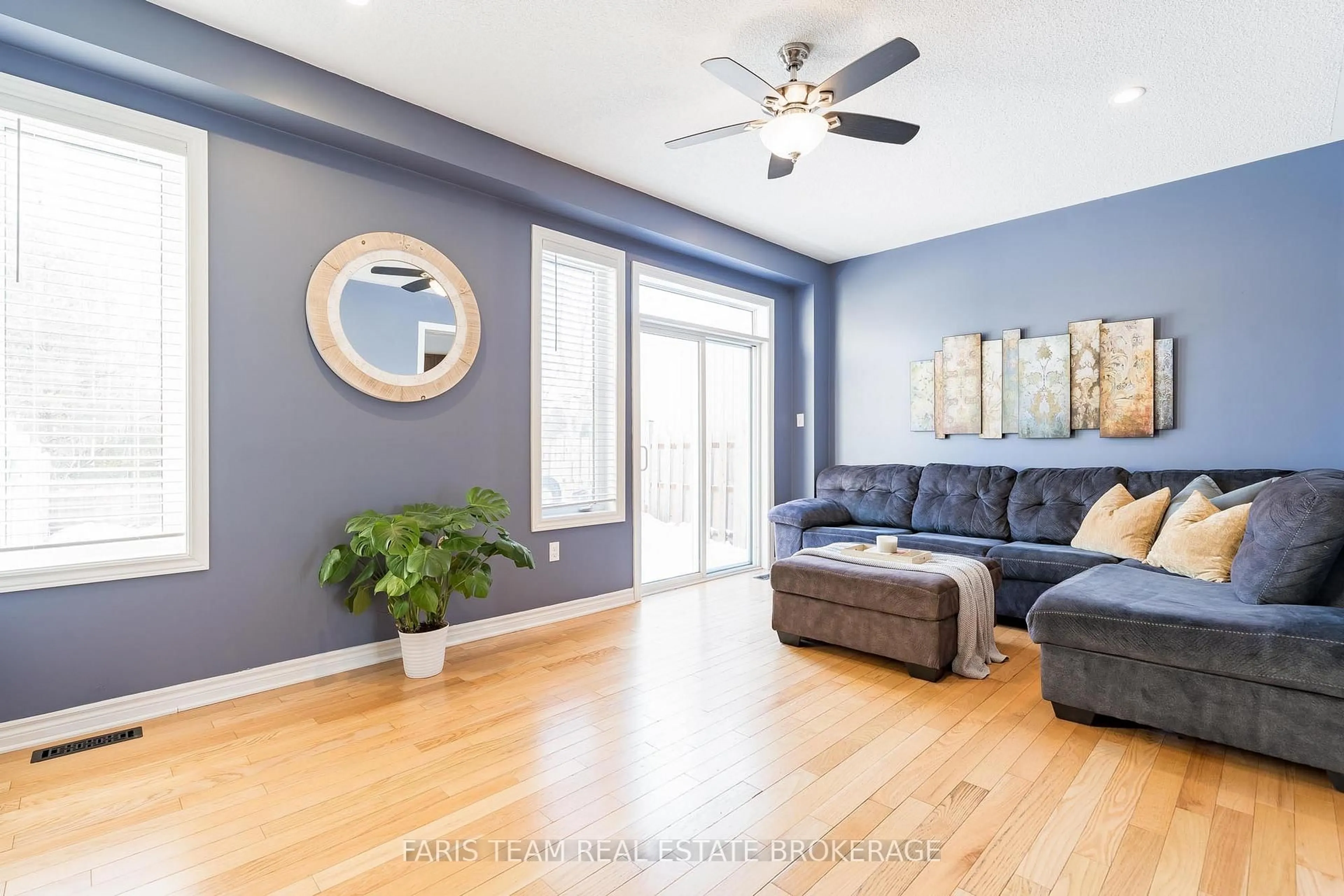 Living room with furniture, wood/laminate floor for 80 Blanchard Cres, Essa Ontario L3W 0M9