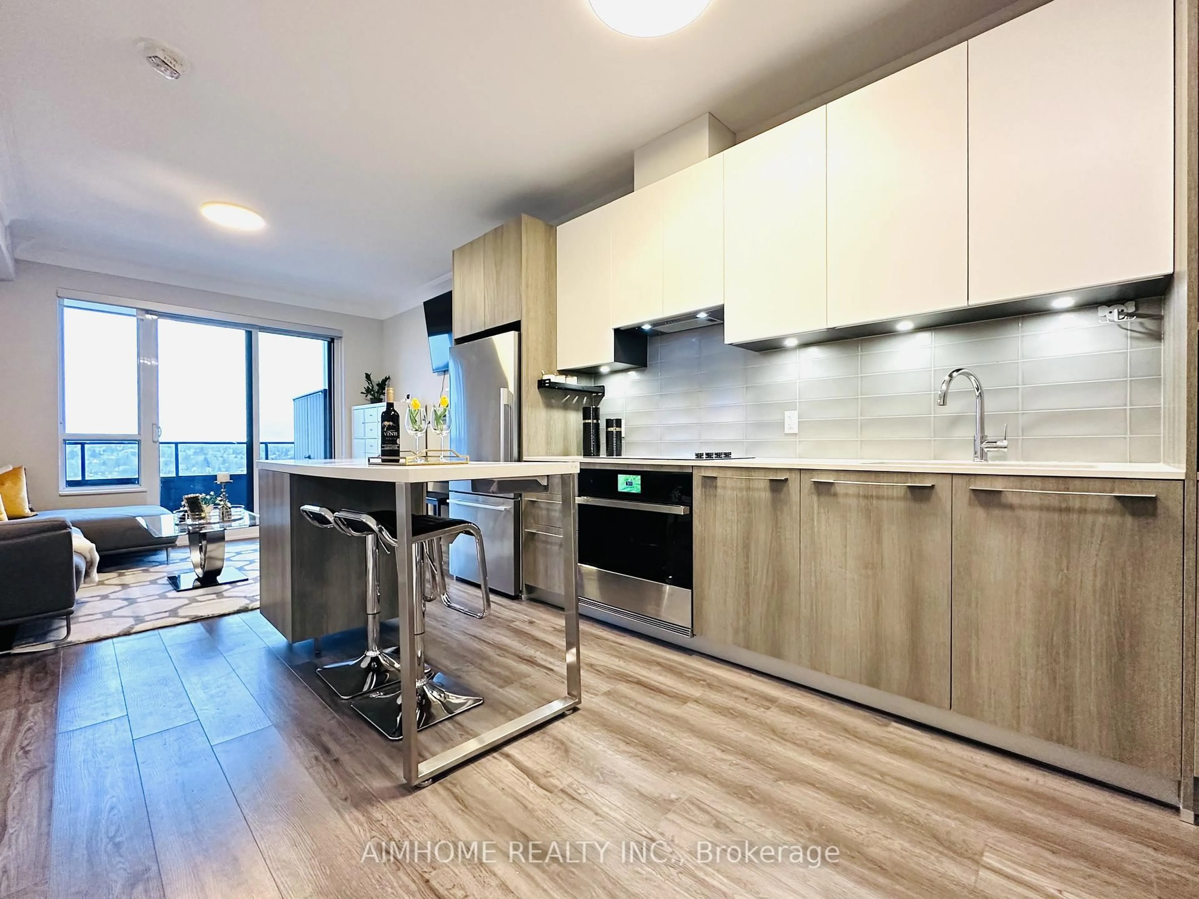 Open concept kitchen, wood/laminate floor for 38 Water Walk Dr #910, Markham Ontario L3R 6M8