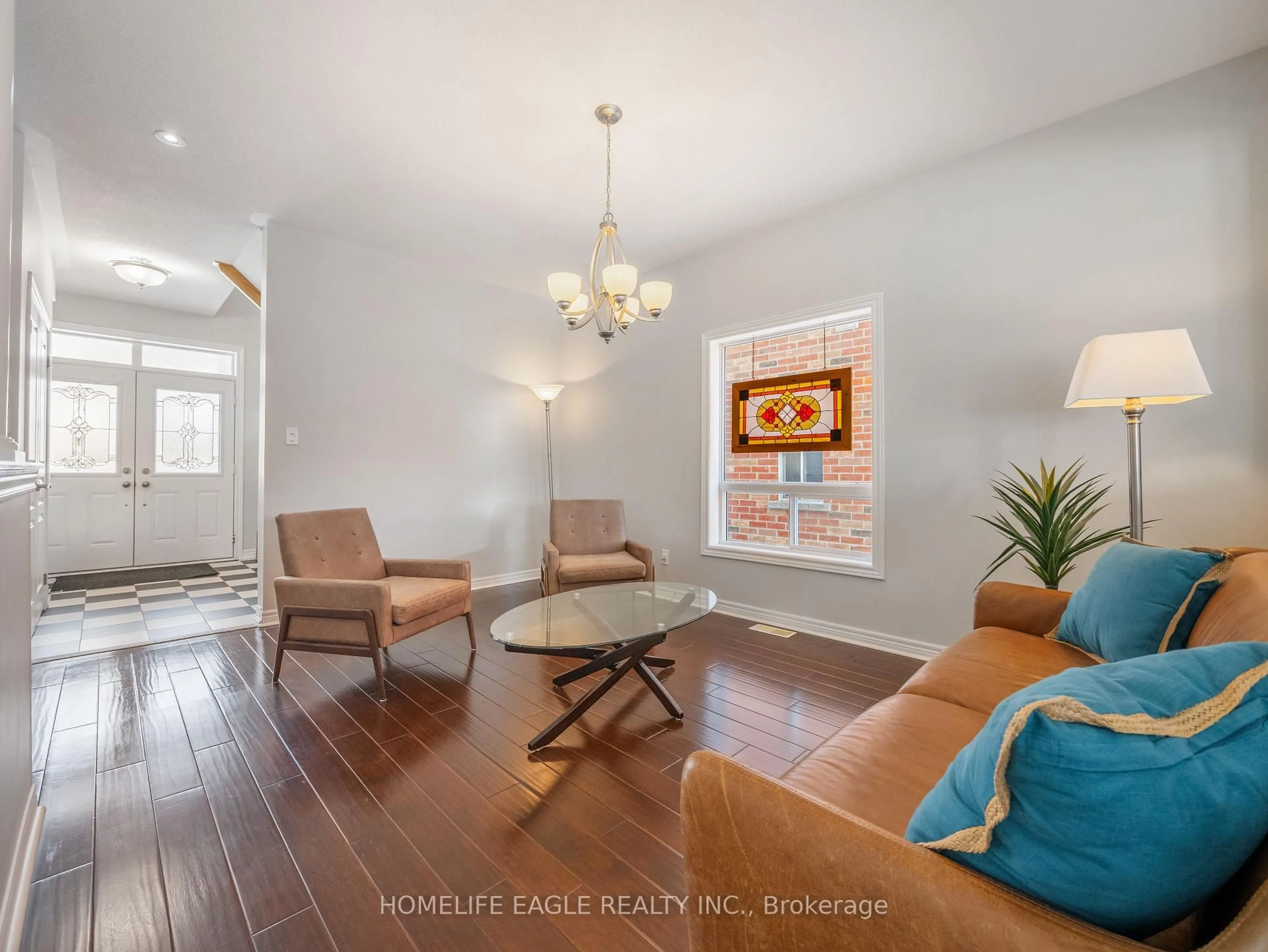 Living room with furniture, wood/laminate floor for 37 Bramsey St, Georgina Ontario L0E 1R0