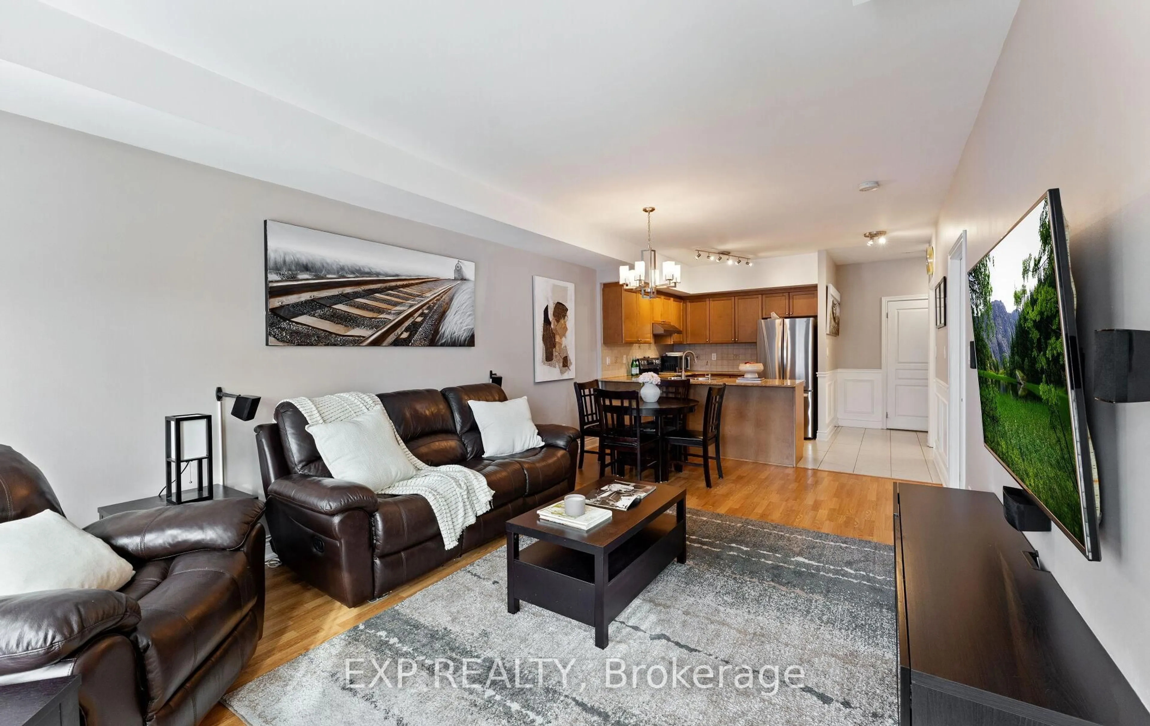 Living room with furniture, wood/laminate floor for 9901 Keele St #208, Vaughan Ontario L6A 0A1