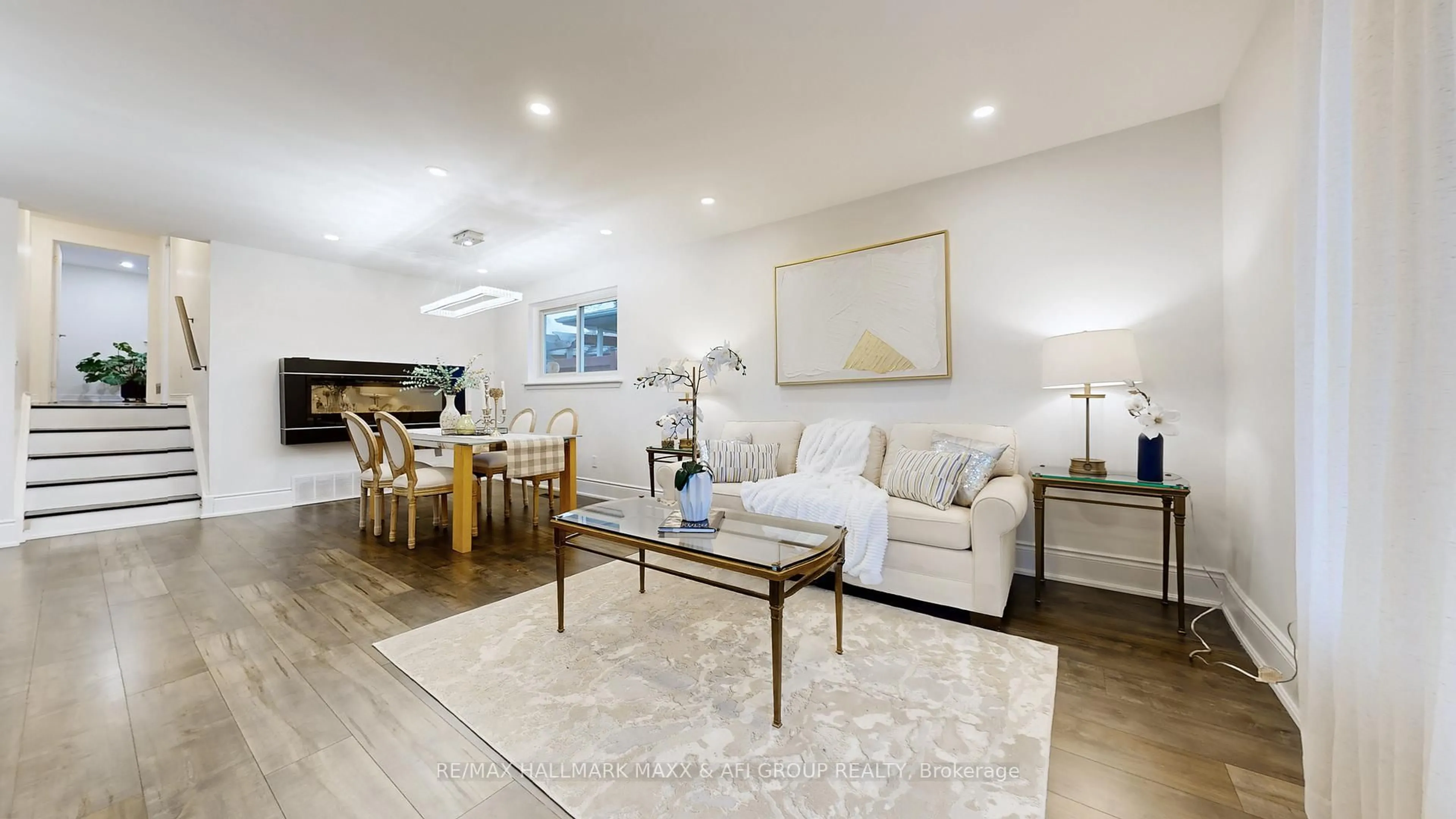 Living room with furniture, wood/laminate floor for 42 Devins Dr, Aurora Ontario L4G 2Z1