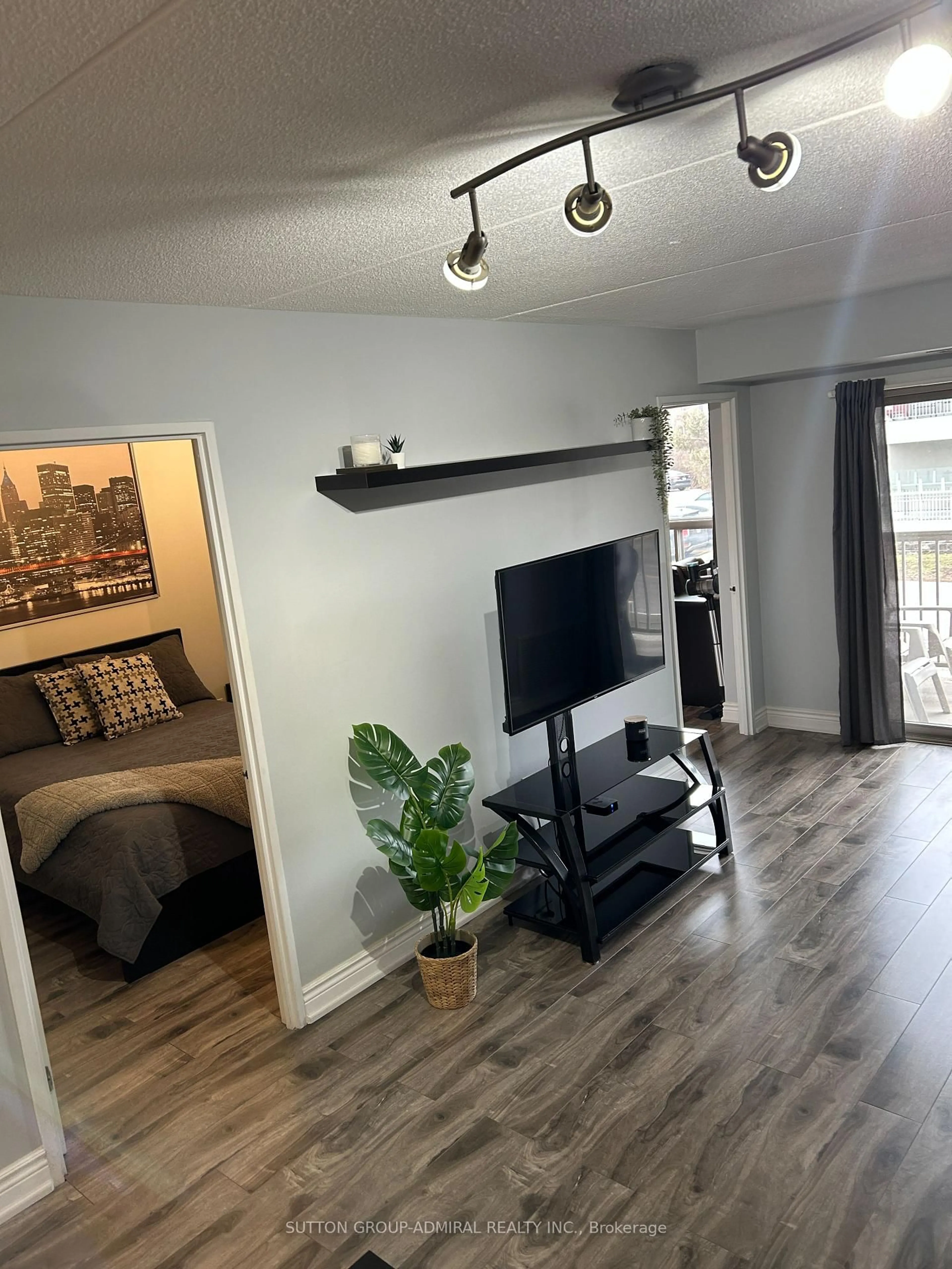 Living room with furniture, wood/laminate floor for 250 Pine Grove Rd #216, Vaughan Ontario L4L 9M6