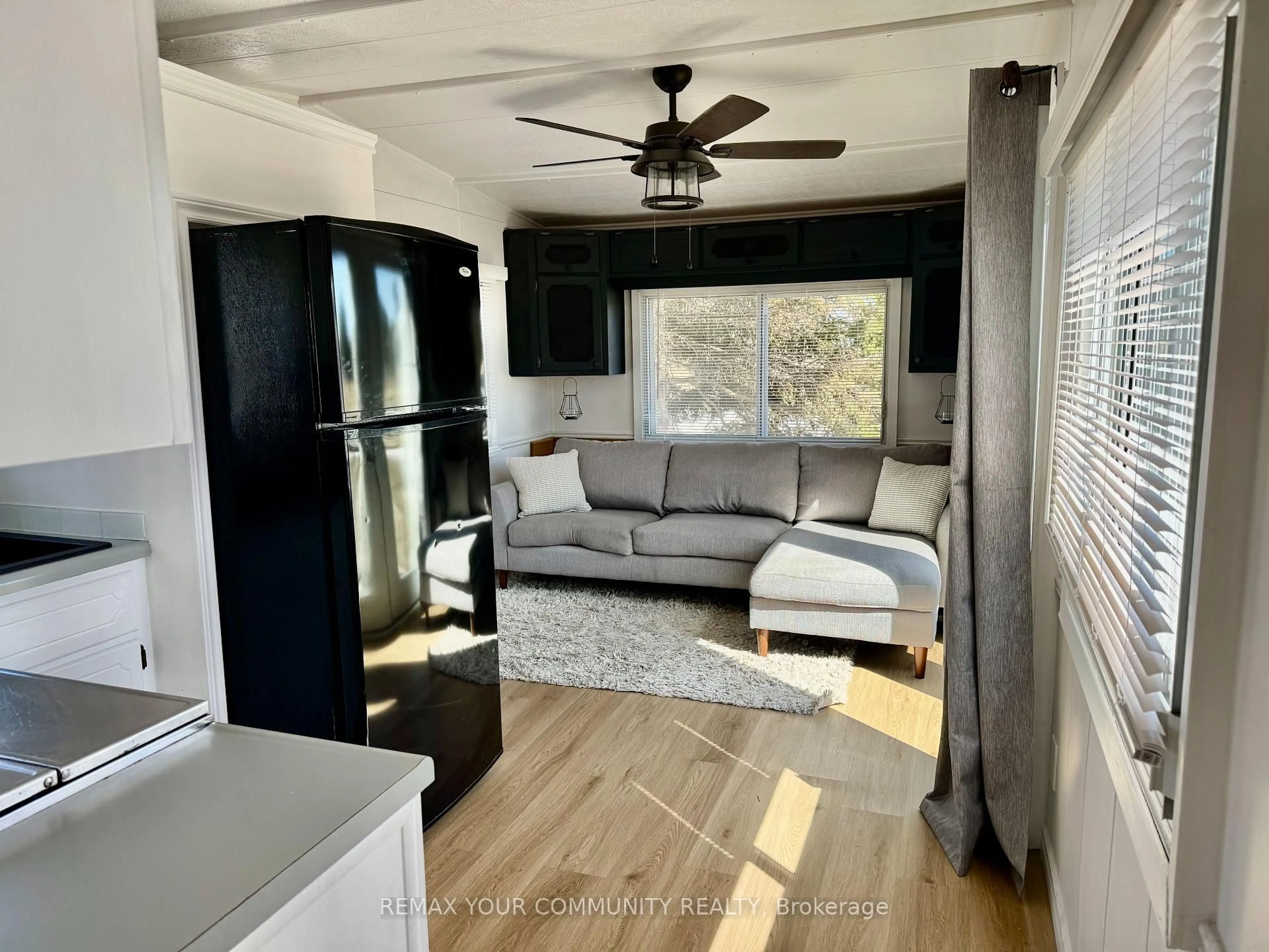 Living room with furniture, wood/laminate floor for 285 Crydermans Sdrd #204, Georgina Ontario L0E 1A0