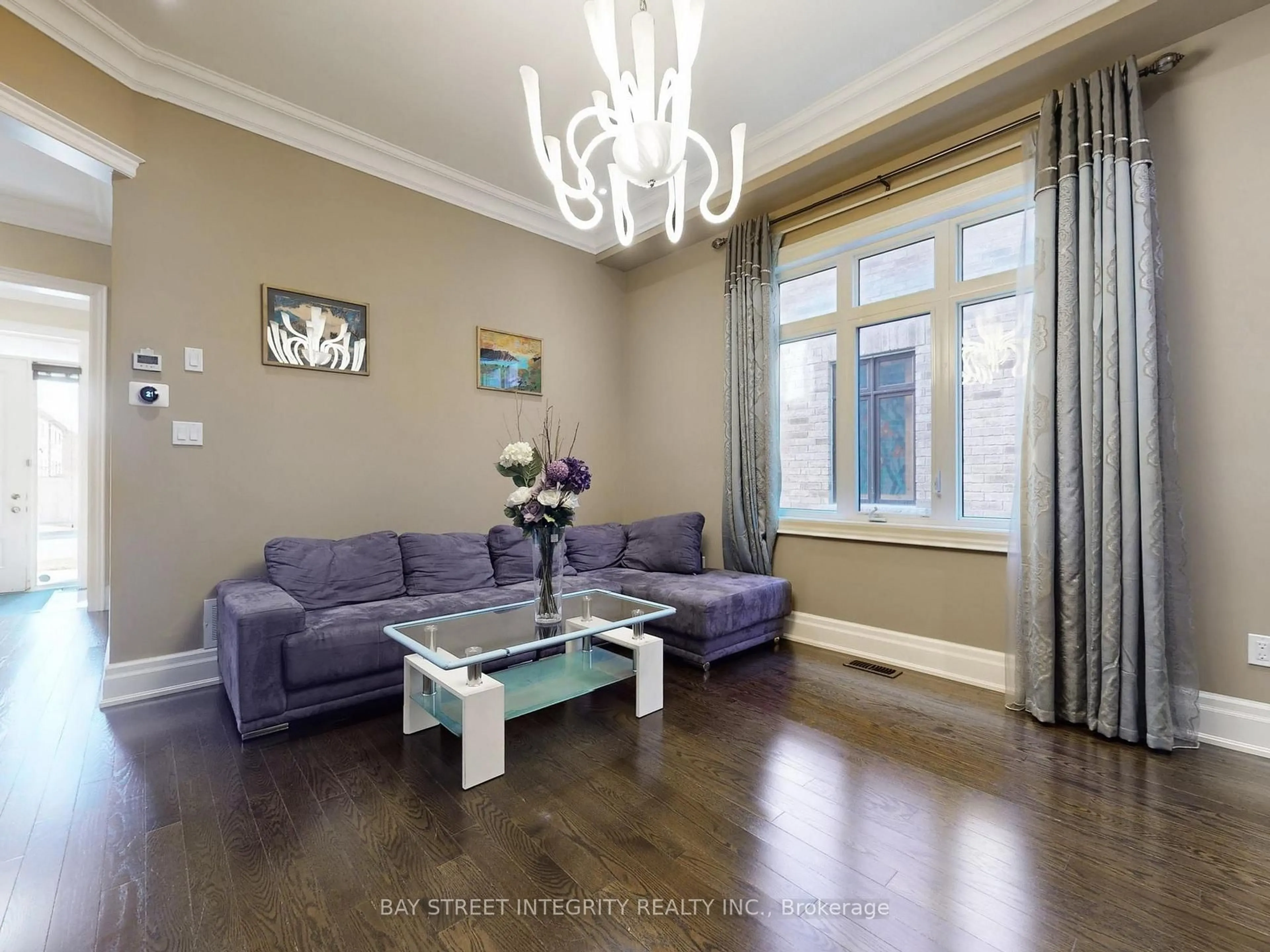 Living room with furniture, wood/laminate floor for 57 Strawbridge Farm Dr, Aurora Ontario L4G 0L2