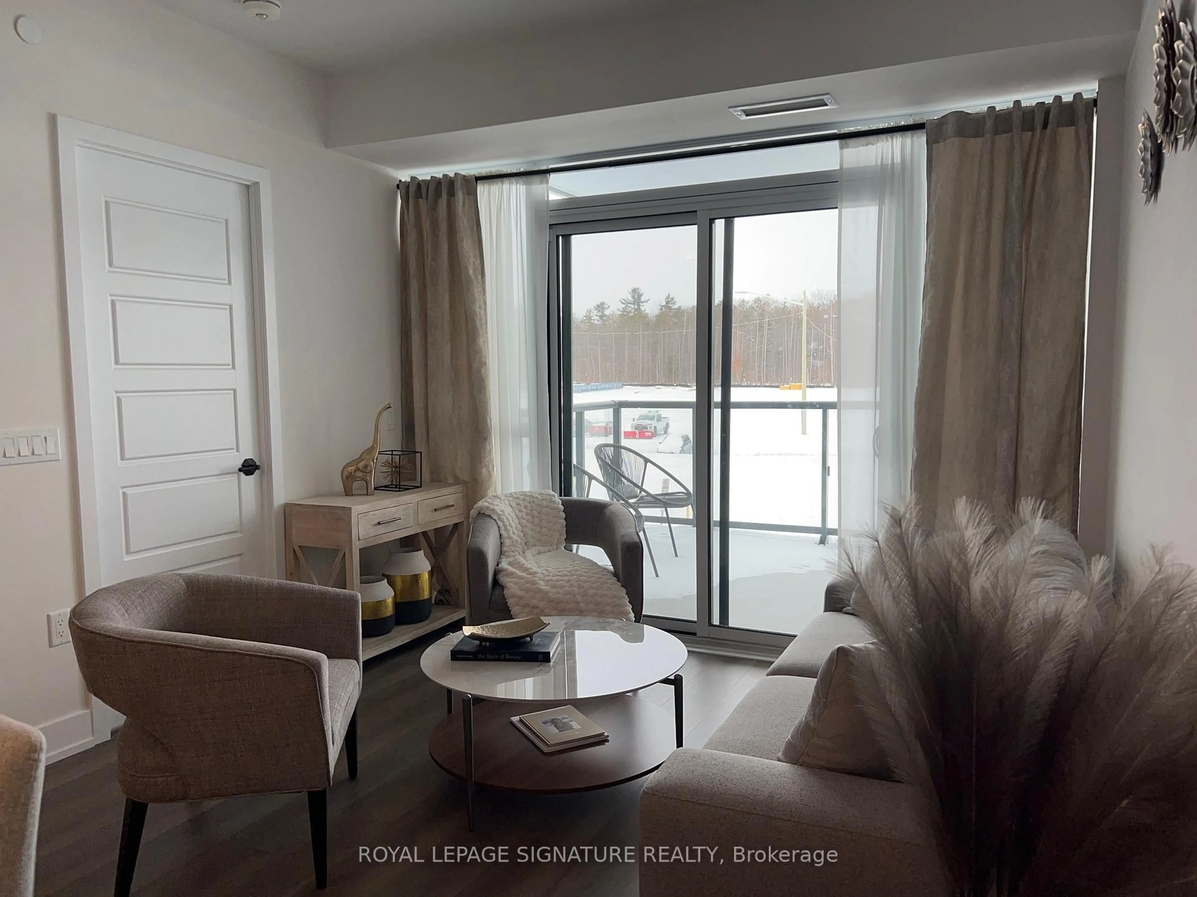 Living room with furniture, wood/laminate floor for 415 Sea Ray Ave #207, Innisfil Ontario L9S 0R5