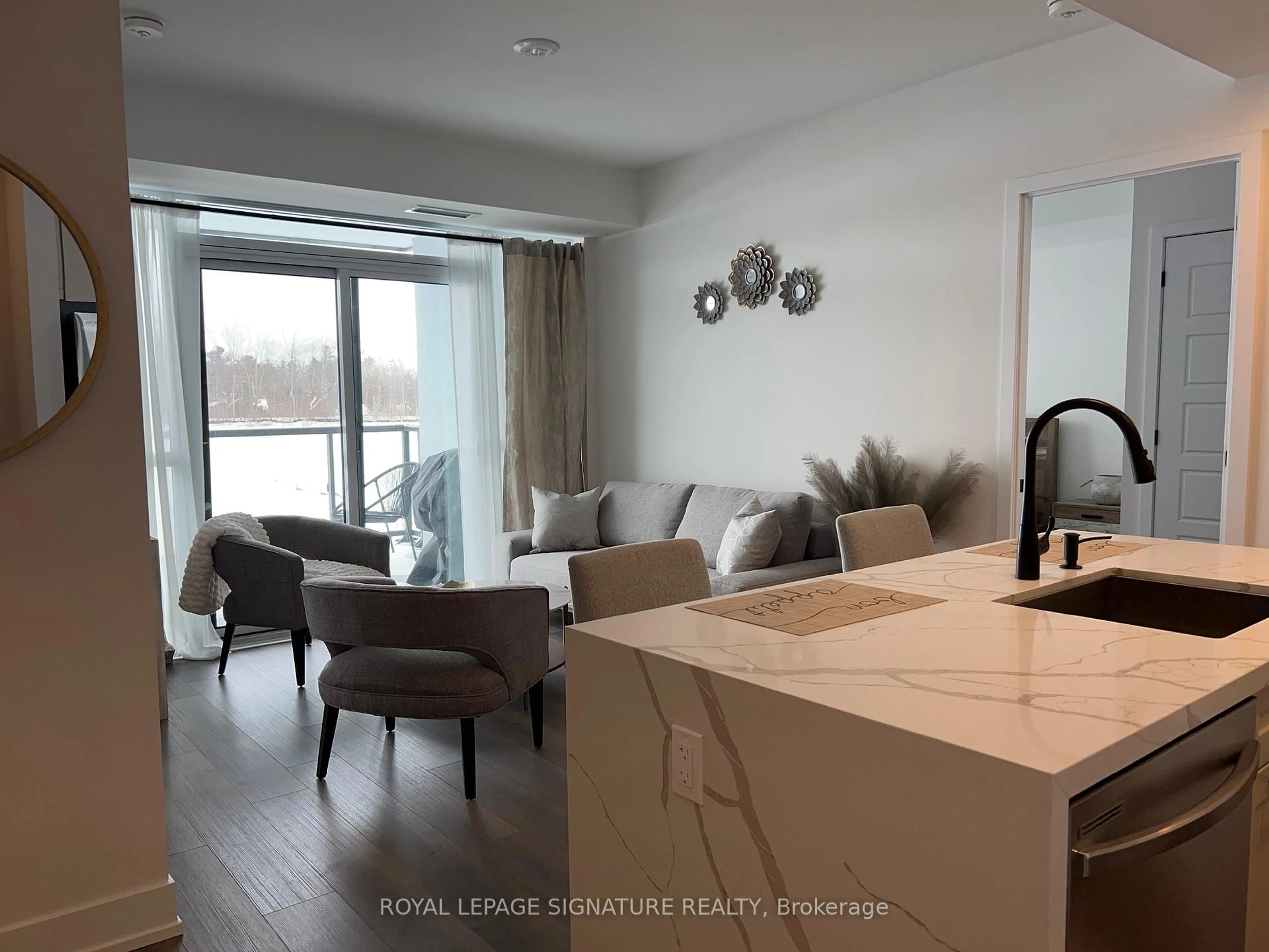 Living room with furniture, wood/laminate floor for 415 Sea Ray Ave #207, Innisfil Ontario L9S 0R5