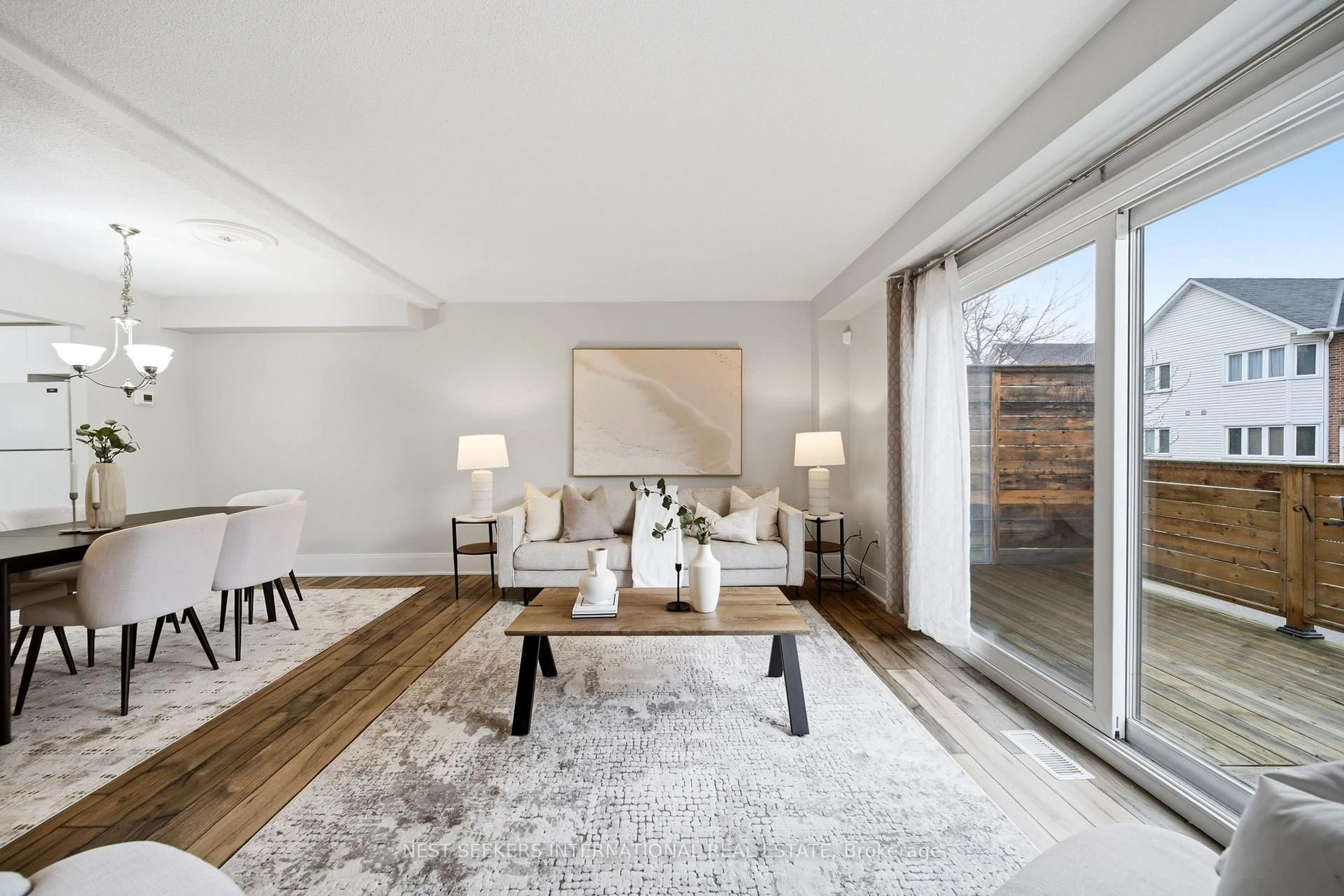 Living room with furniture, wood/laminate floor for 217 Woodbridge Ave #1, Vaughan Ontario L4L 2T1