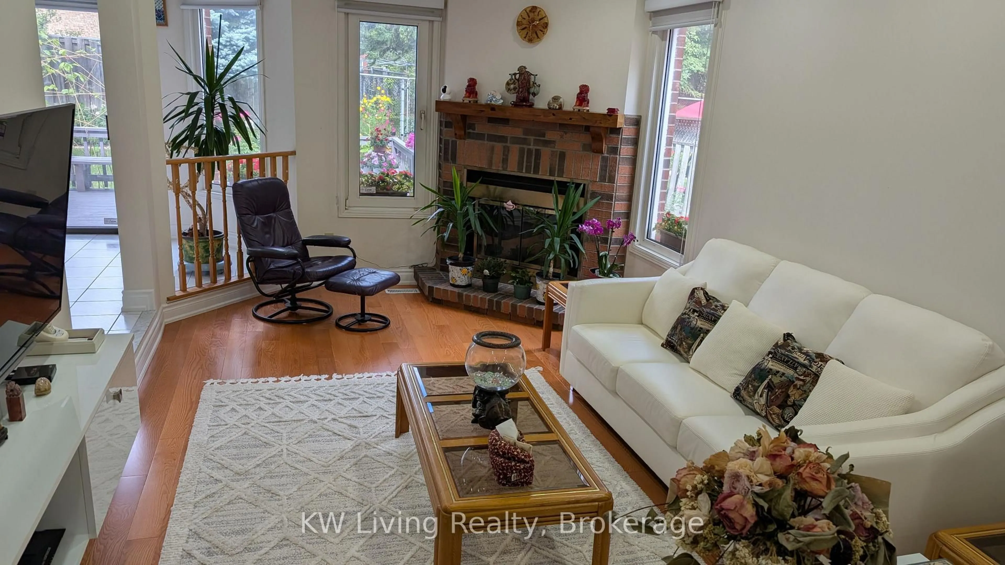 Living room with furniture, wood/laminate floor for 215 Hollingham Rd, Markham Ontario L3R 8K4