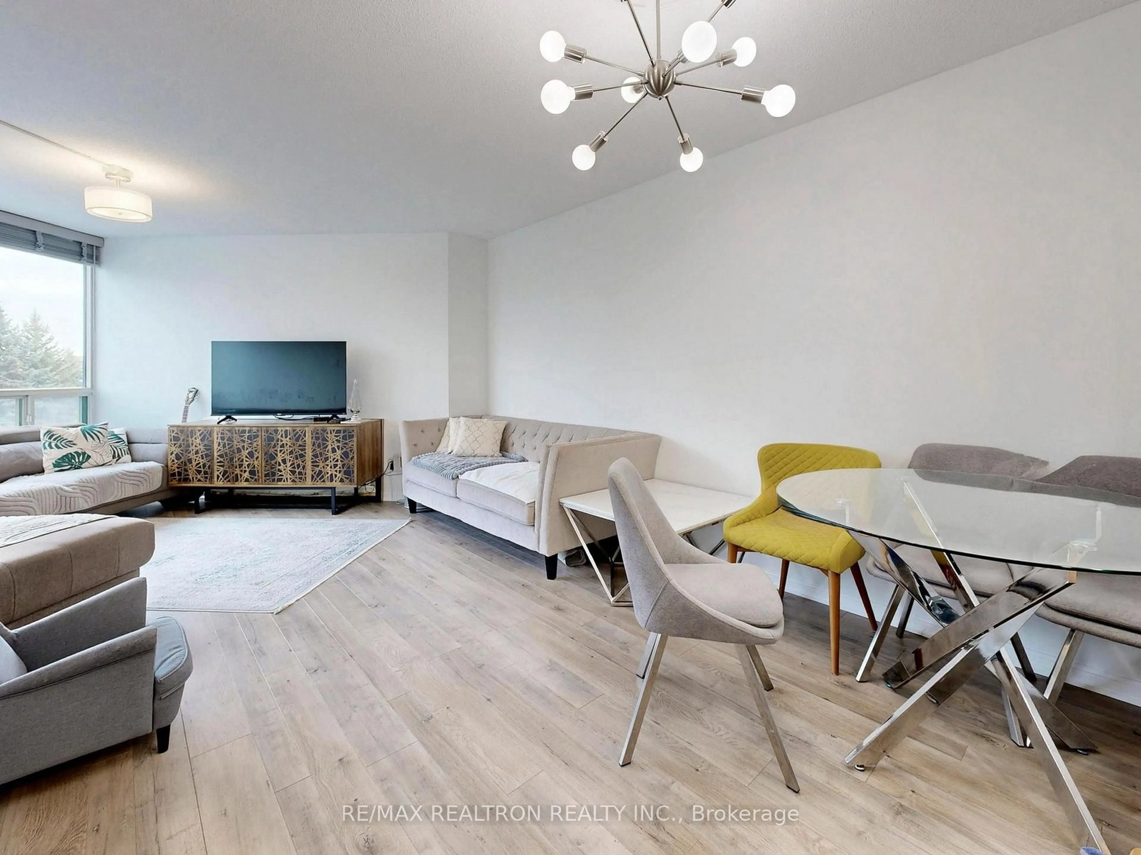 Living room with furniture, wood/laminate floor for 120 Promenade Circ #406, Vaughan Ontario L4J 7W9