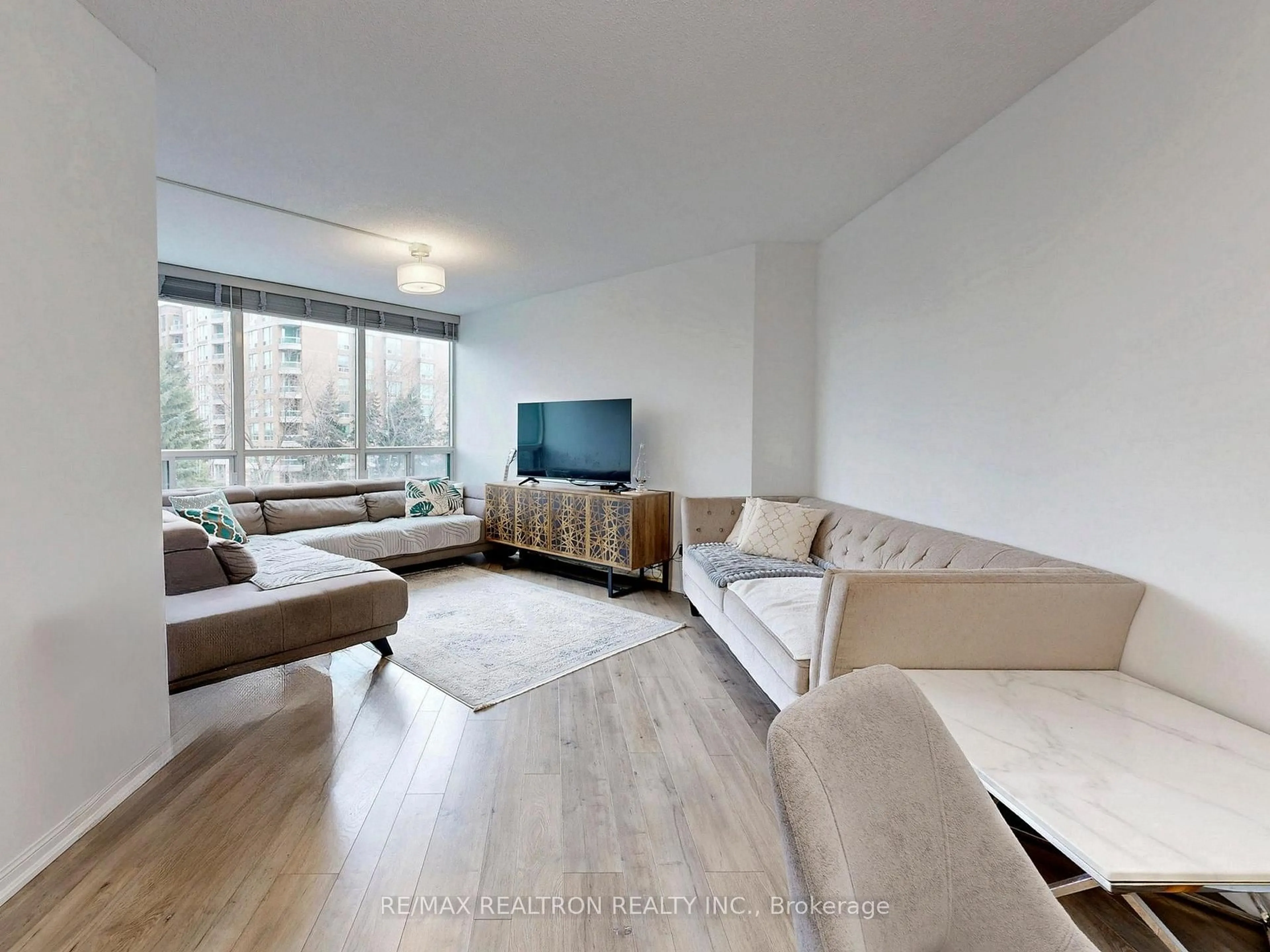 Living room with furniture, wood/laminate floor for 120 Promenade Circ #406, Vaughan Ontario L4J 7W9