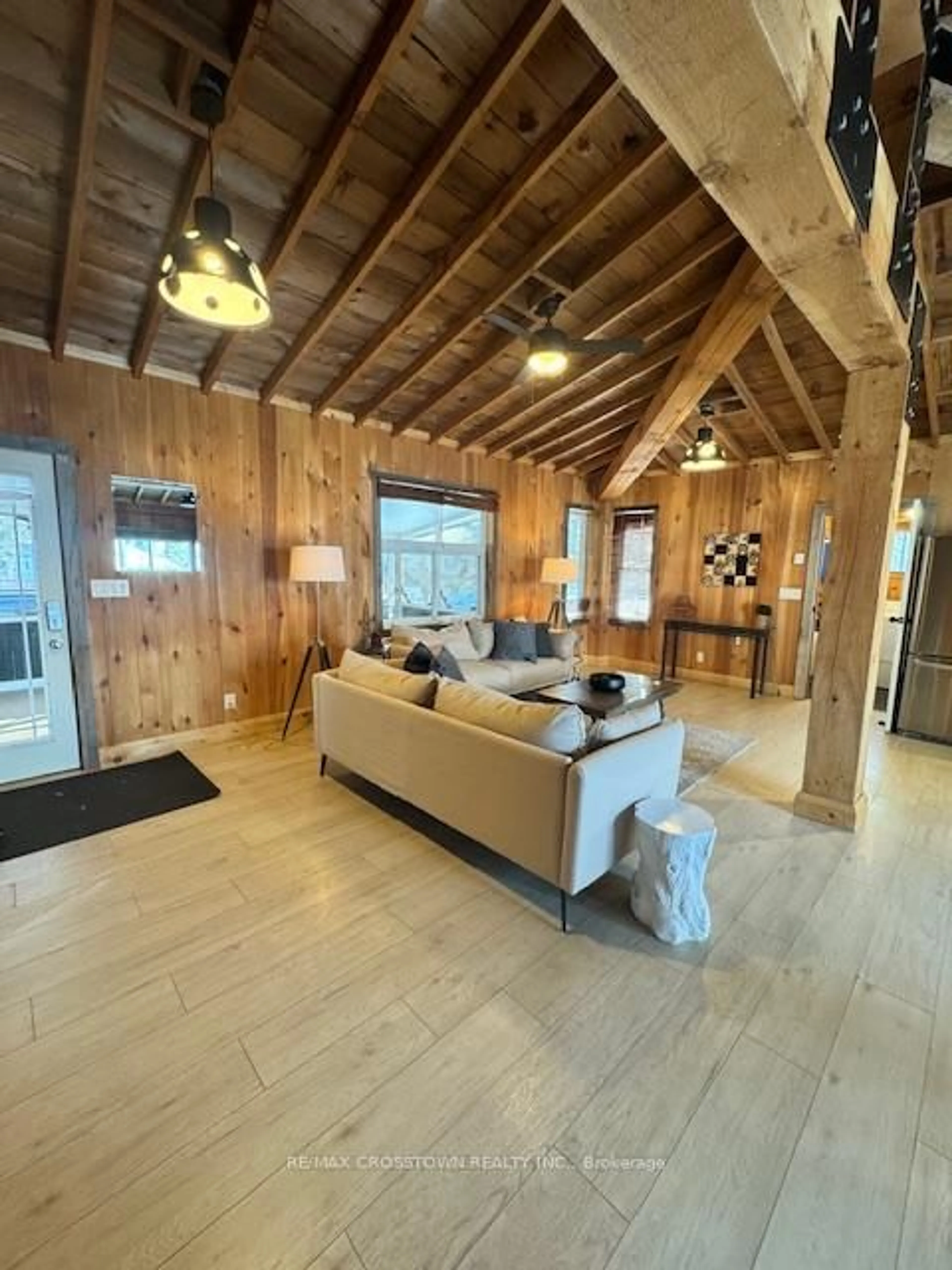 Living room with furniture, wood/laminate floor for 1056 Elm Rd, Innisfil Ontario L9S 2E9