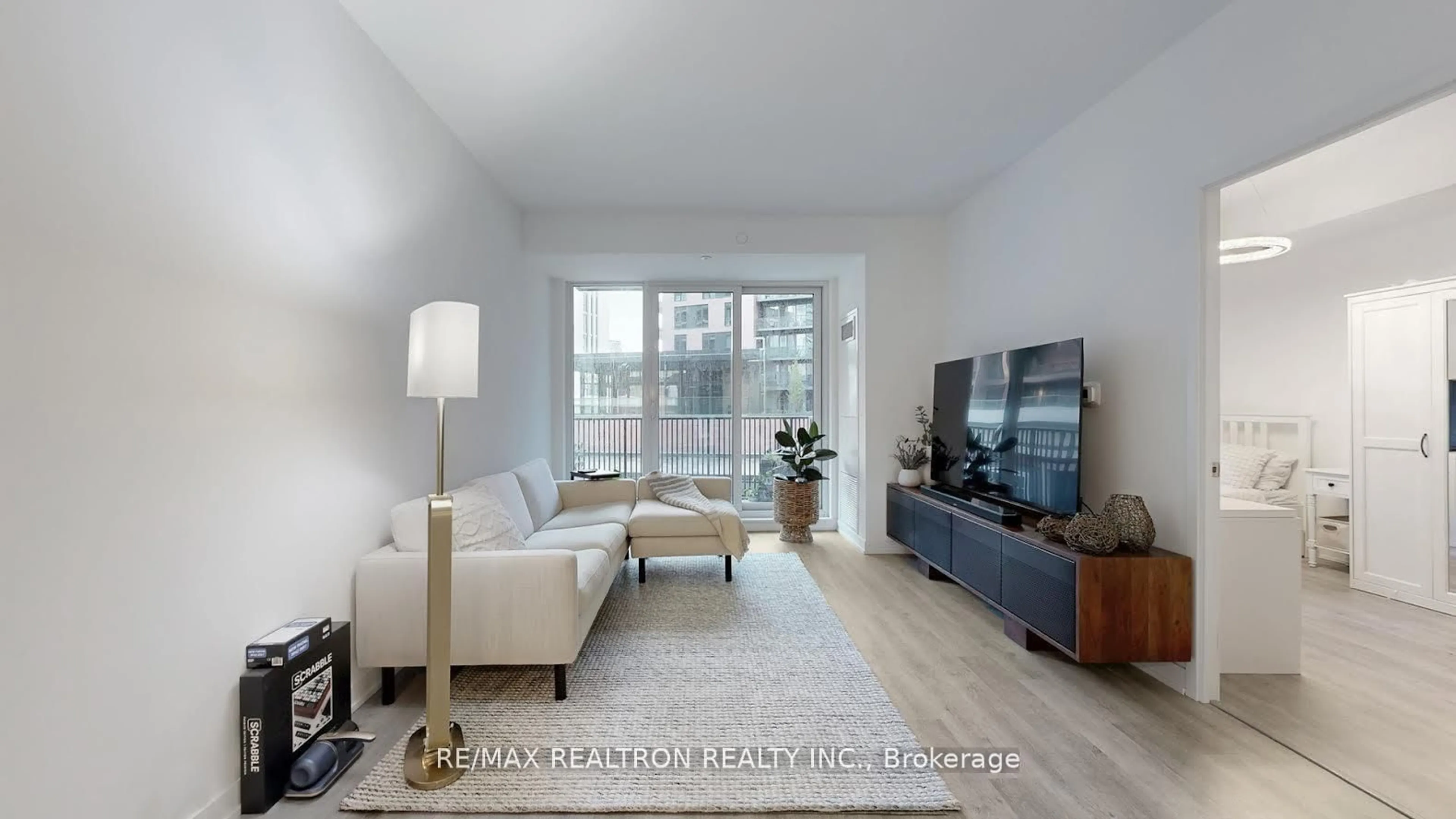 Living room with furniture, wood/laminate floor for 38 Simcoe Promenade Circ #319C, Markham Ontario L6G 0H7