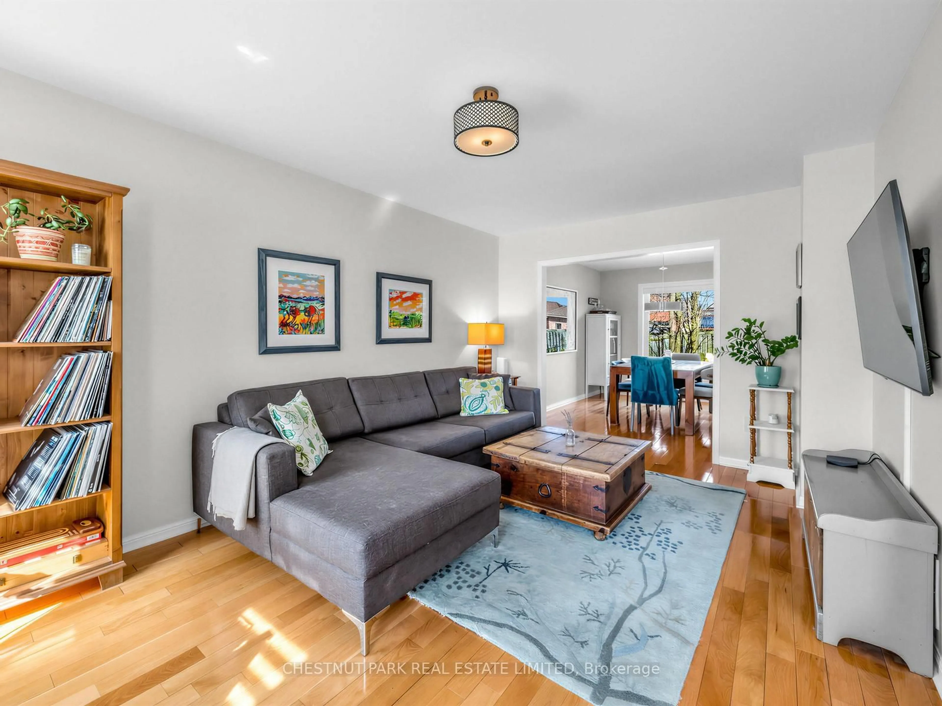 Living room with furniture, wood/laminate floor for 67 Barton Lane, Uxbridge Ontario L9P 1W2