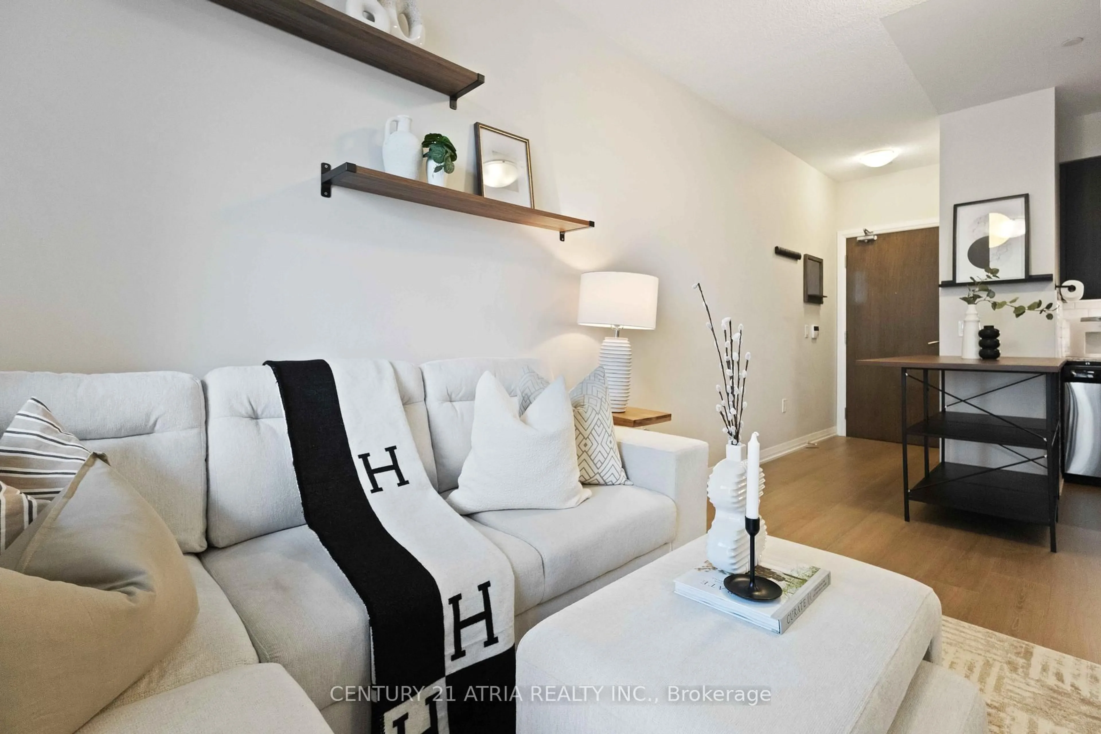 Living room with furniture, wood/laminate floor for 9560 Markham Rd #705, Markham Ontario L6E 0T9