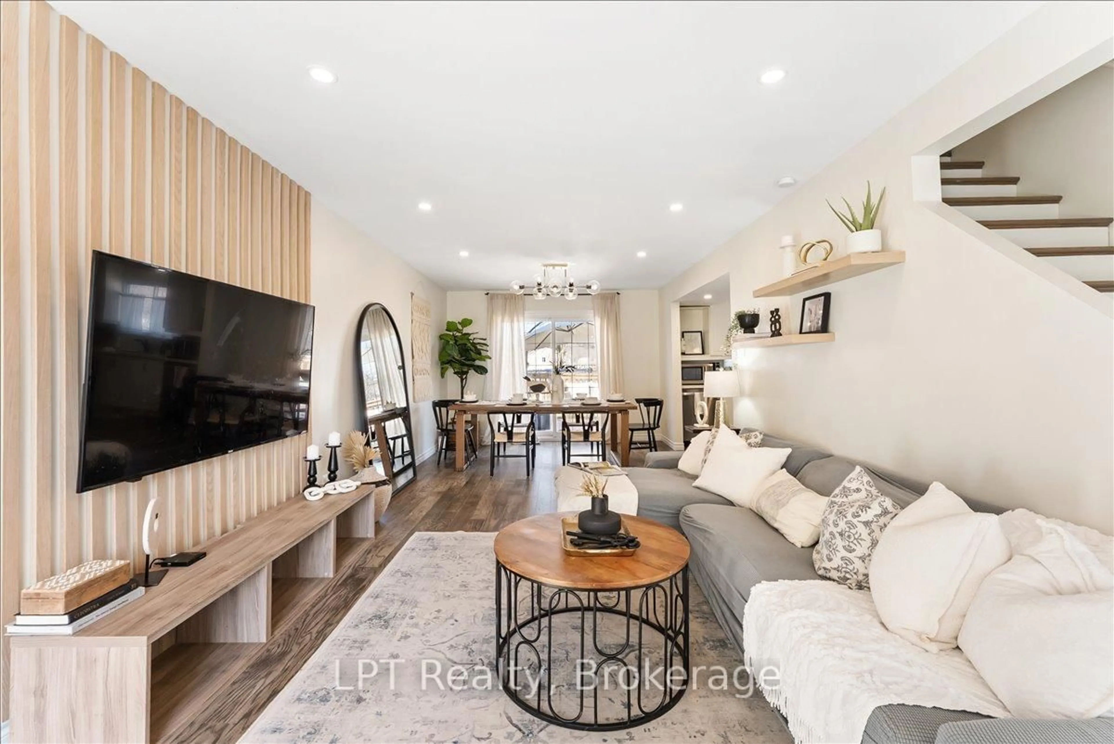 Living room with furniture, wood/laminate floor for 154 Beach Rd, Georgina Ontario L4P 2L7