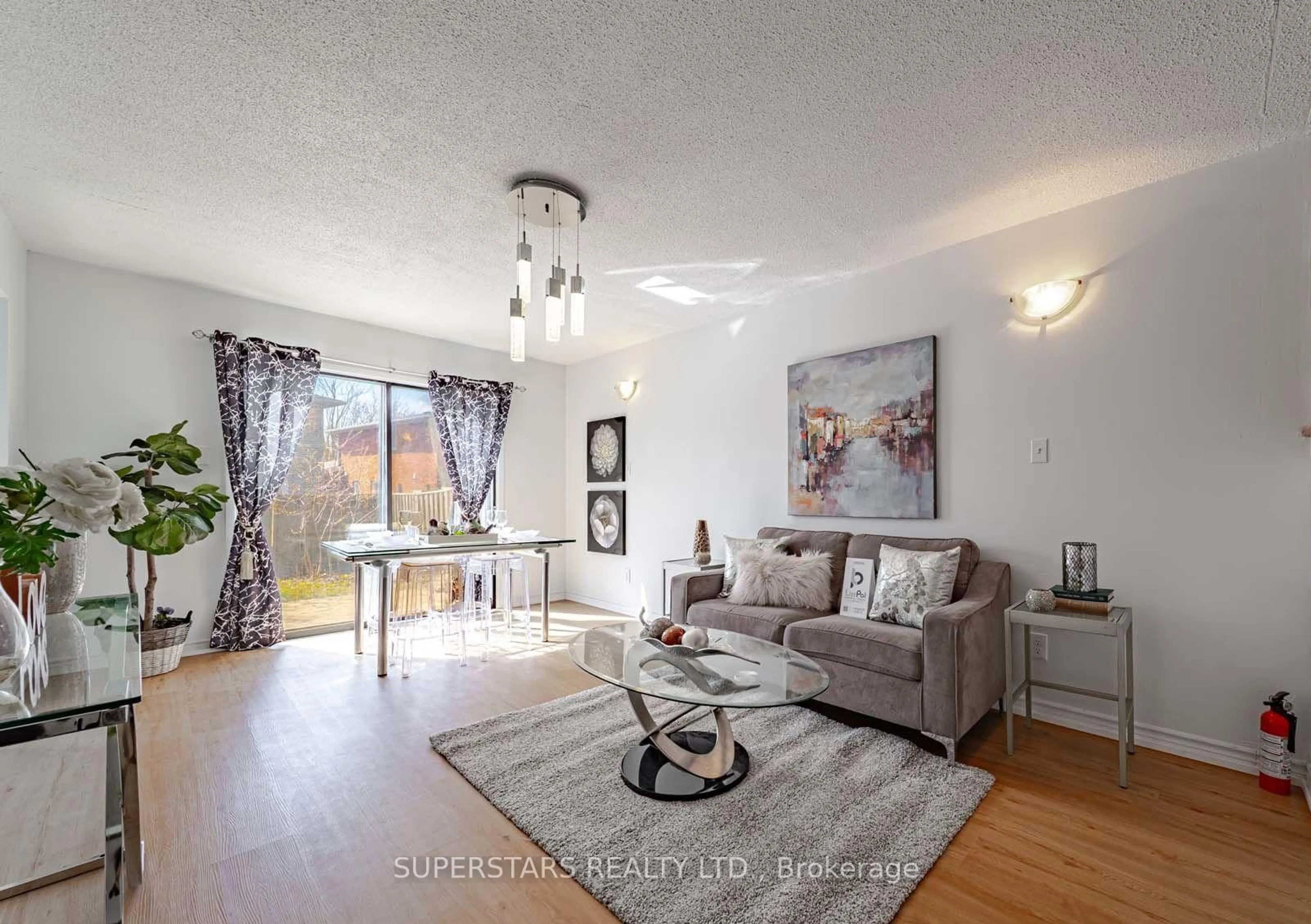Living room with furniture, wood/laminate floor for 135 Appleby Cres, Markham Ontario L3R 4L1