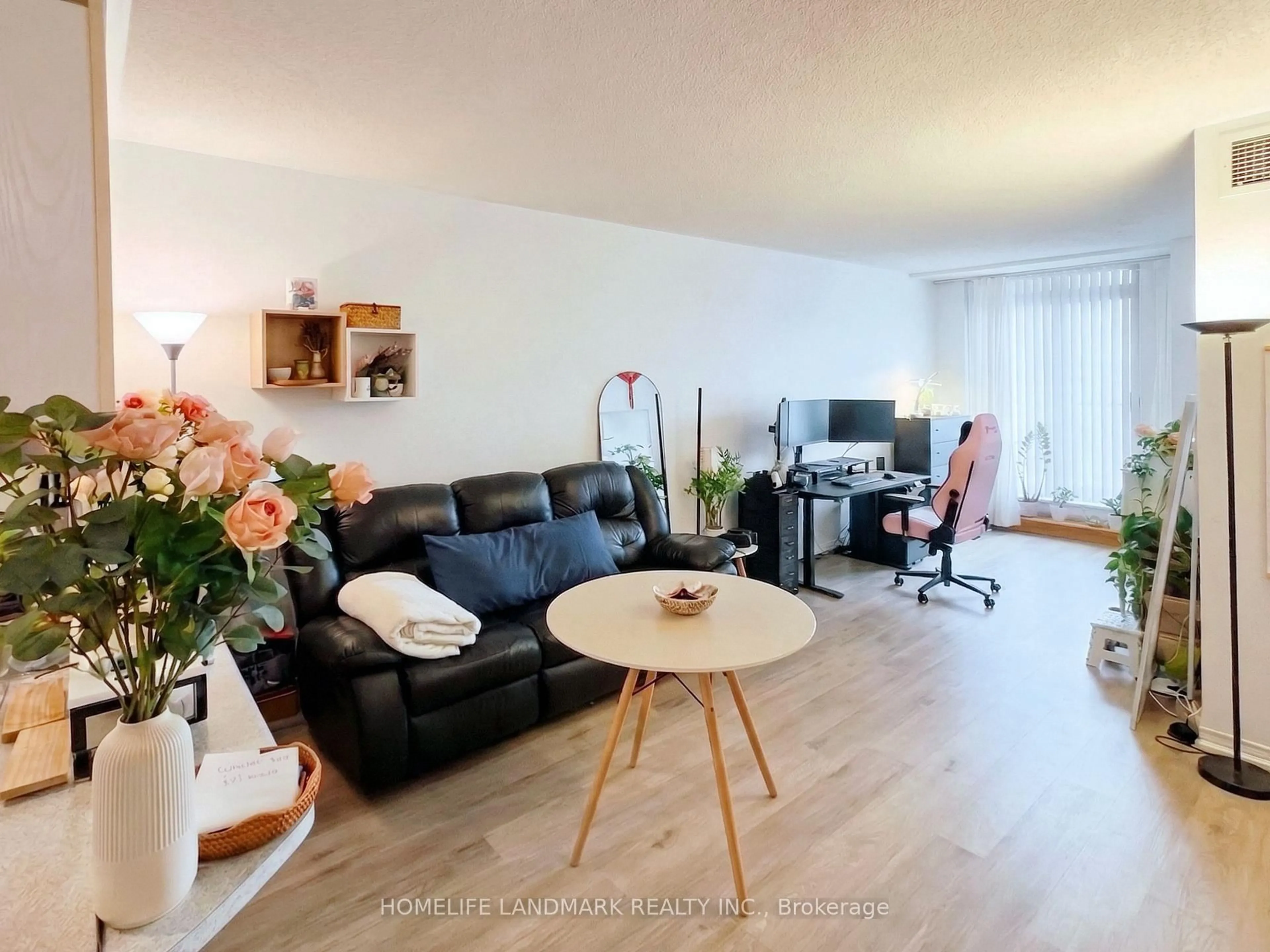 Living room with furniture, wood/laminate floor for 7398 Yonge St #106, Vaughan Ontario L4J 8J2