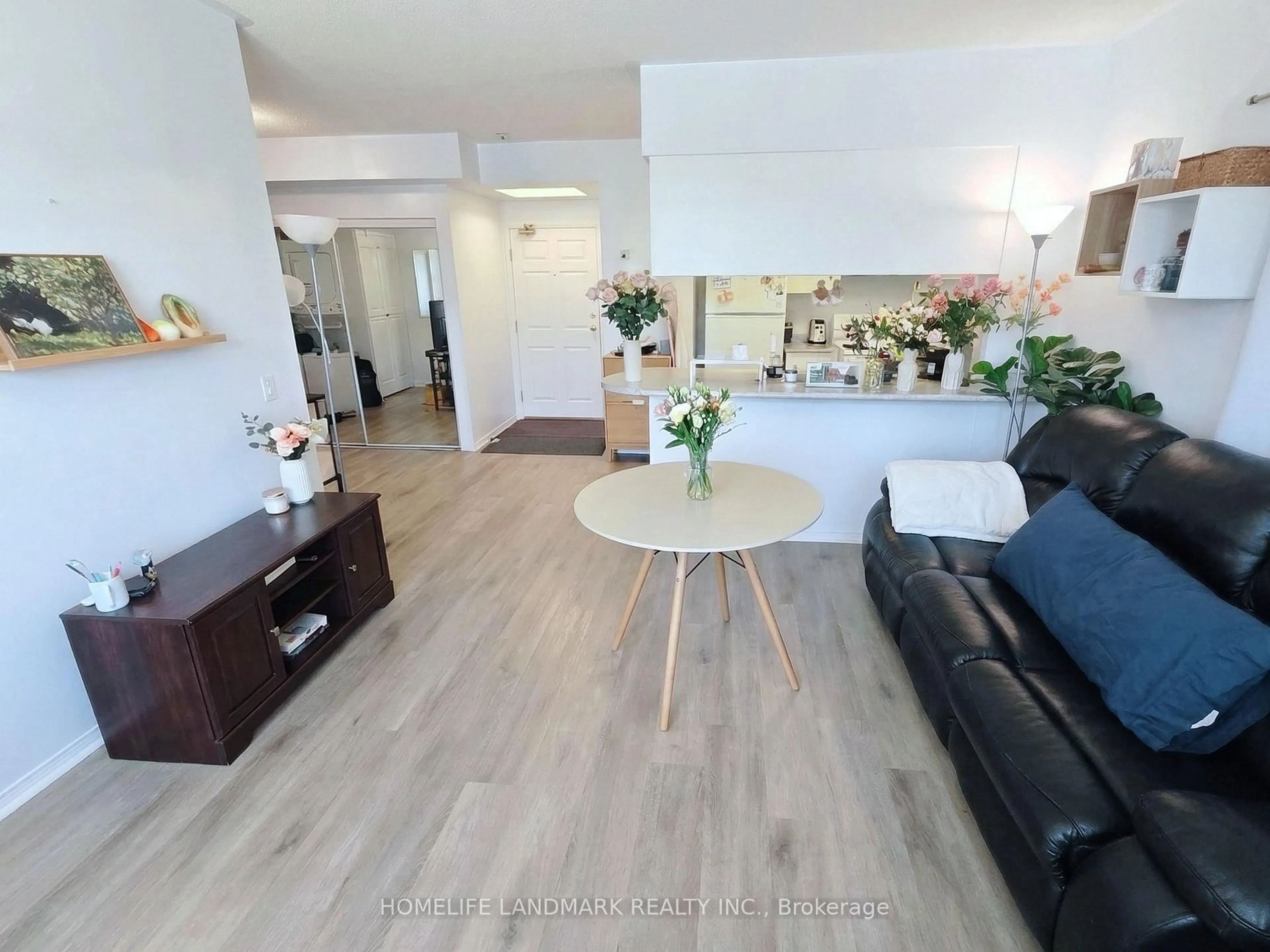 Living room with furniture, wood/laminate floor for 7398 Yonge St #106, Vaughan Ontario L4J 8J2