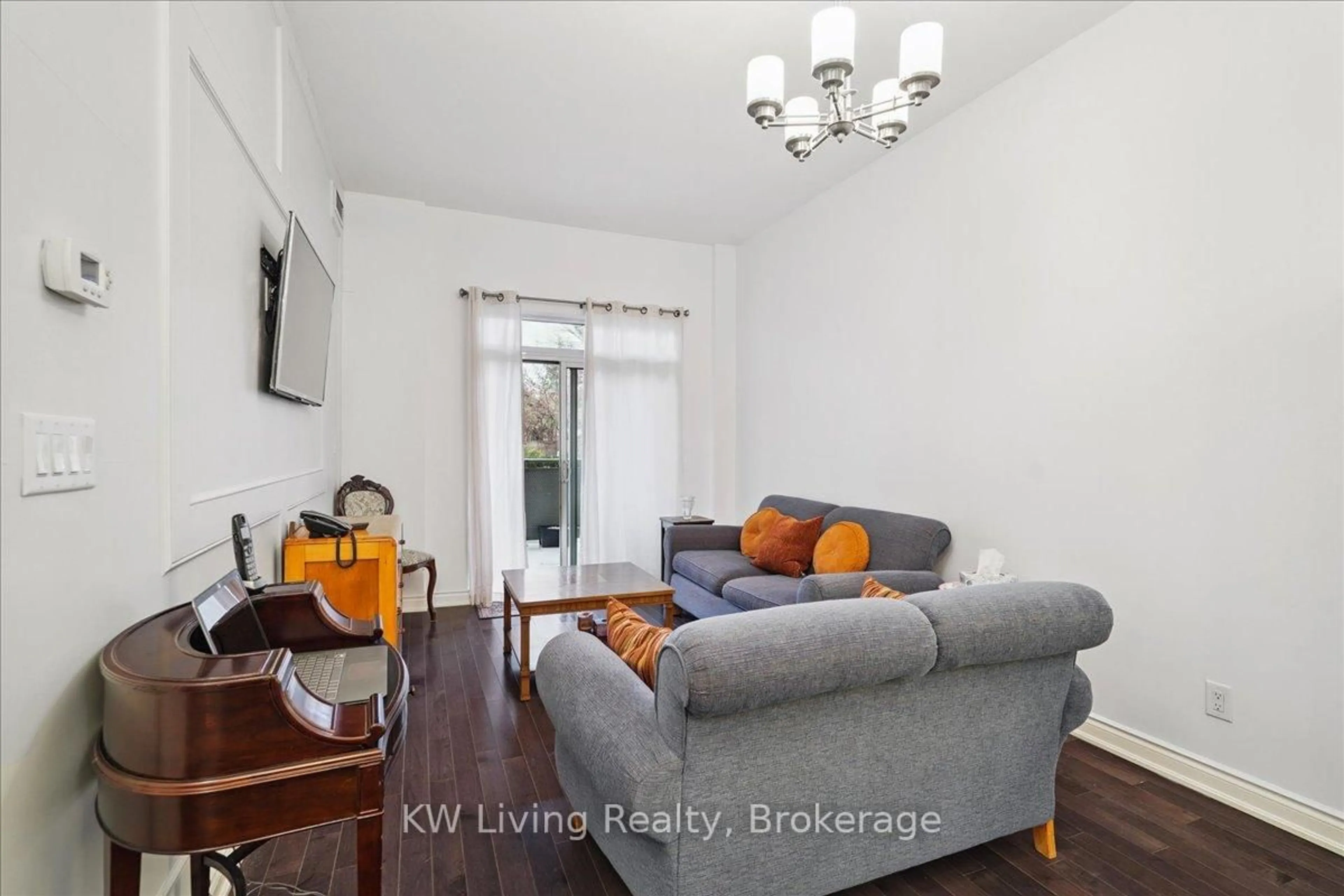Living room with furniture, wood/laminate floor for 281 Woodbridge Ave #112, Vaughan Ontario L4L 0C6