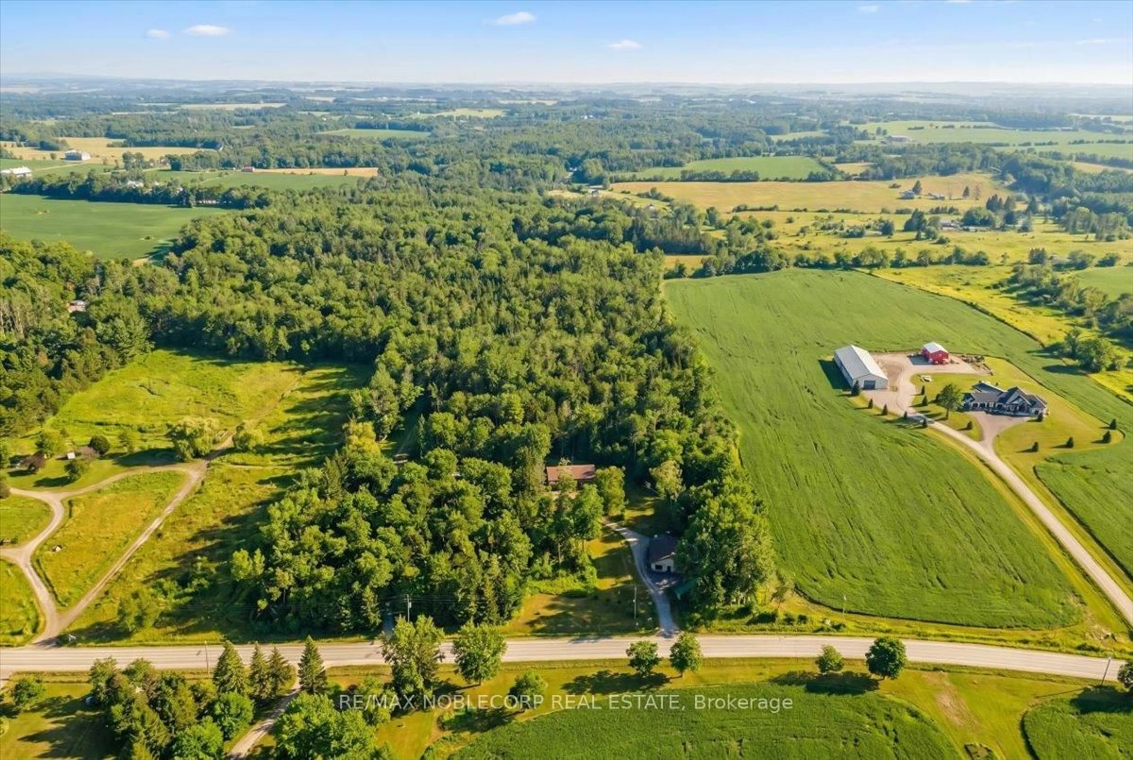 A pic from outside/outdoor area/front of a property/back of a property/a pic from drone, forest/trees view for 1945 10th Sdrd, New Tecumseth Ontario L0G 1W0