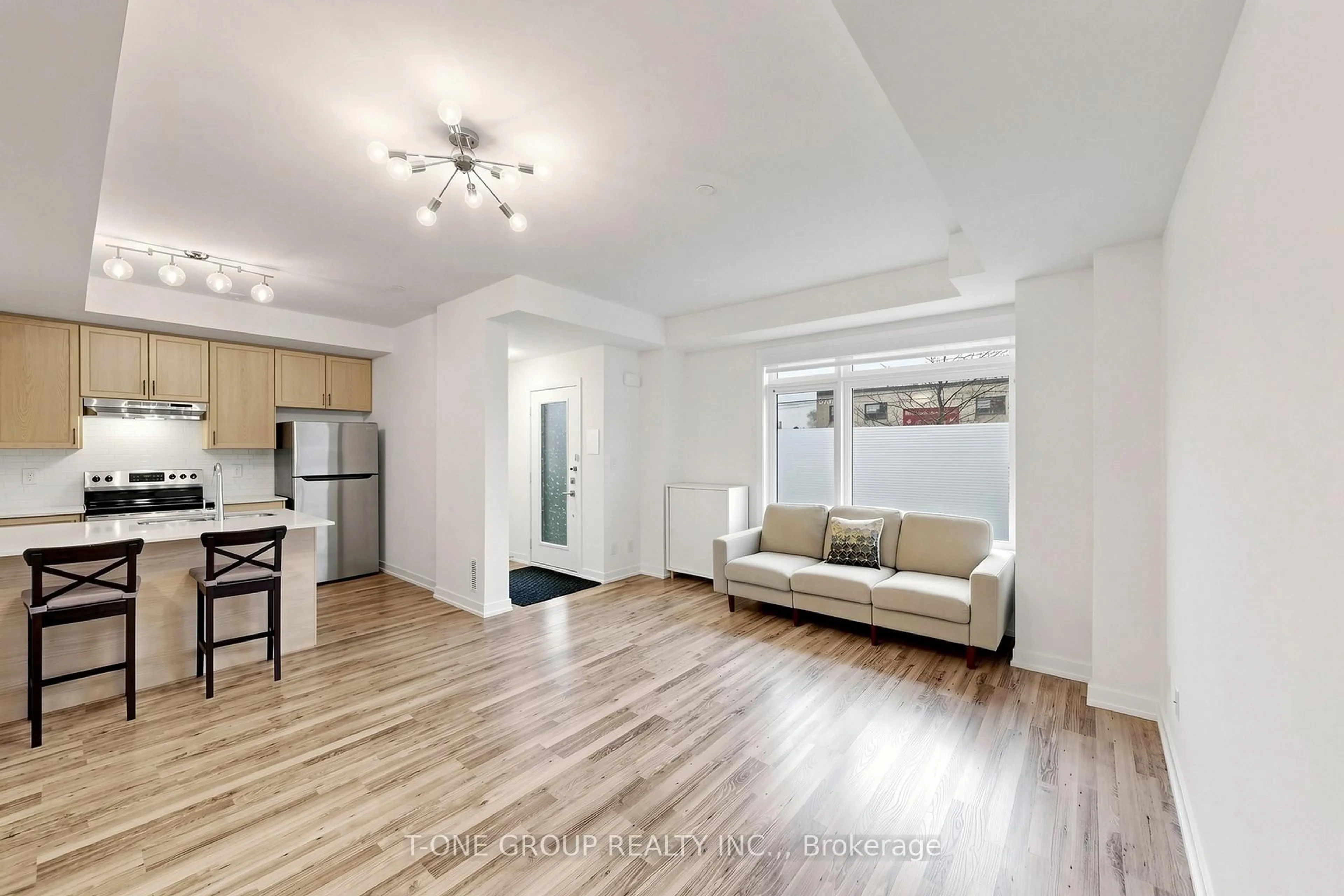 Living room with furniture, wood/laminate floor for 370 Red Maple Rd #106, Richmond Hill Ontario L4C 6P5