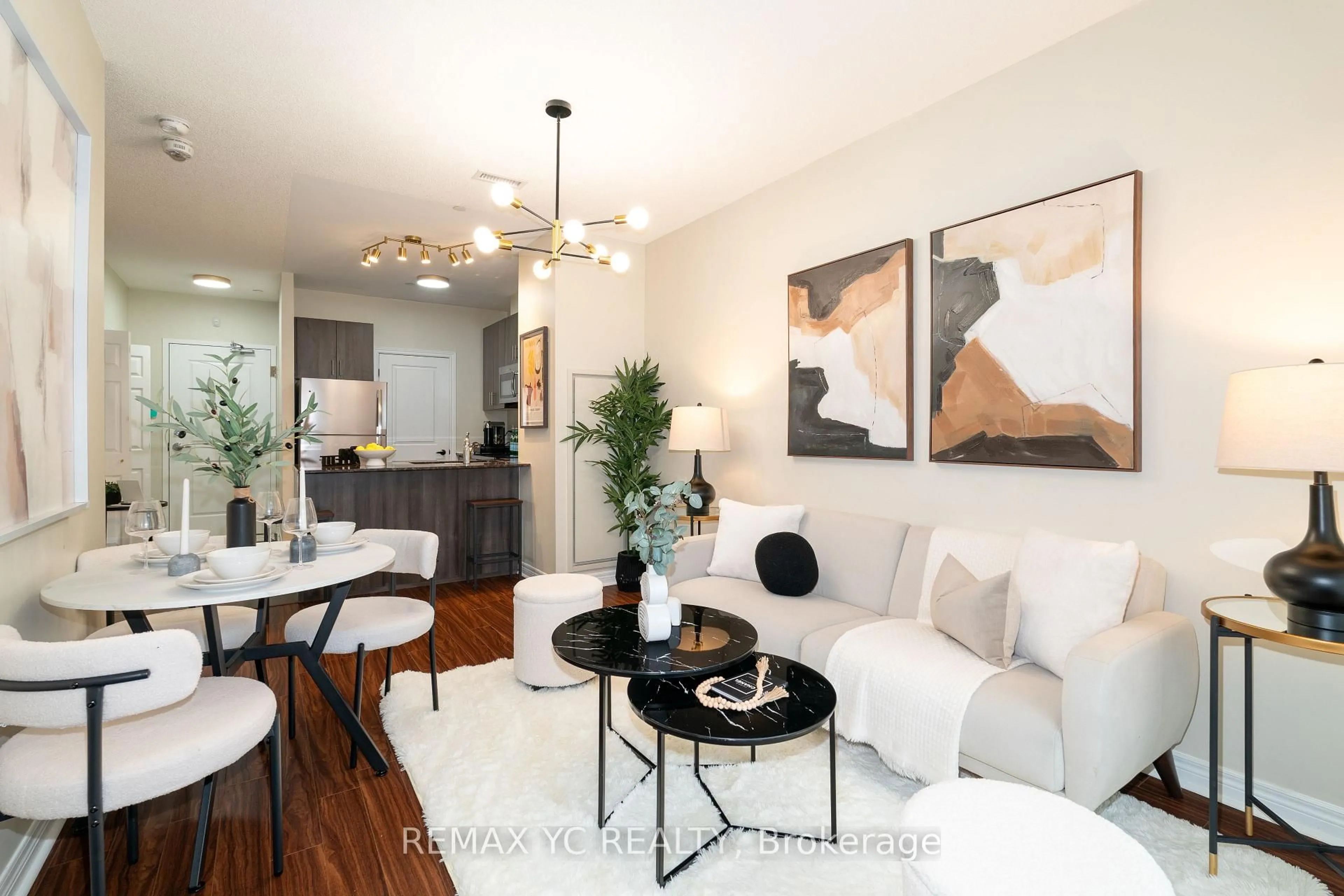 Living room with furniture, wood/laminate floor for 7768 Kennedy Rd #102, Markham Ontario L3R 5K1