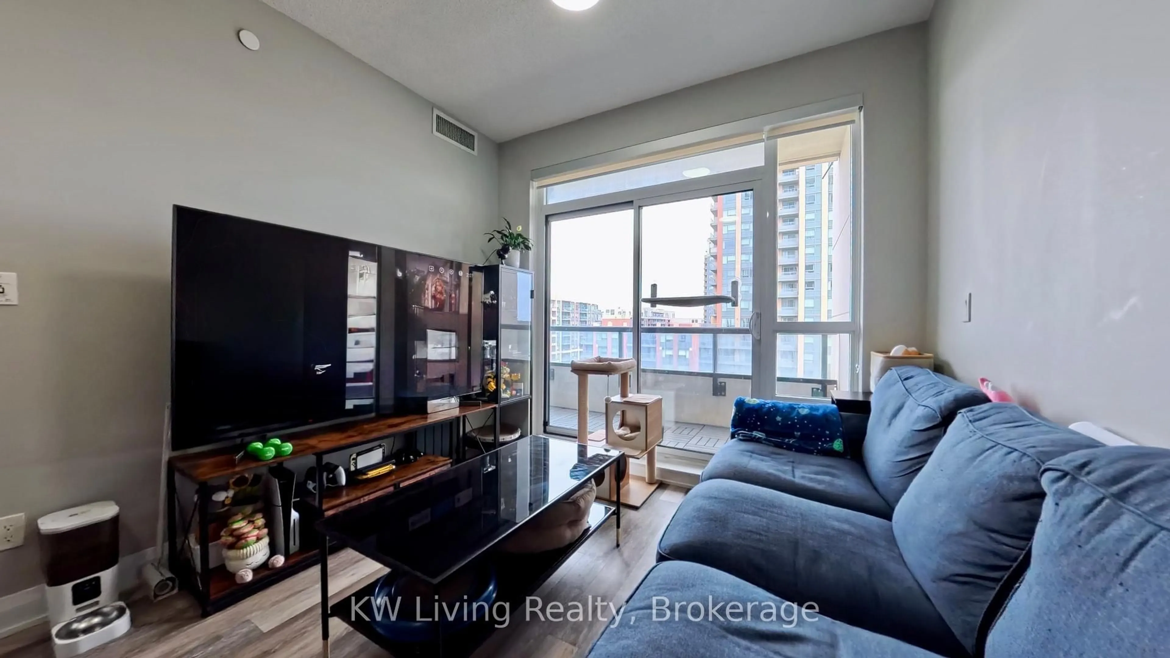 Living room with furniture, wood/laminate floor for 15 Water Walk Dr #711, Markham Ontario L6G 0G2