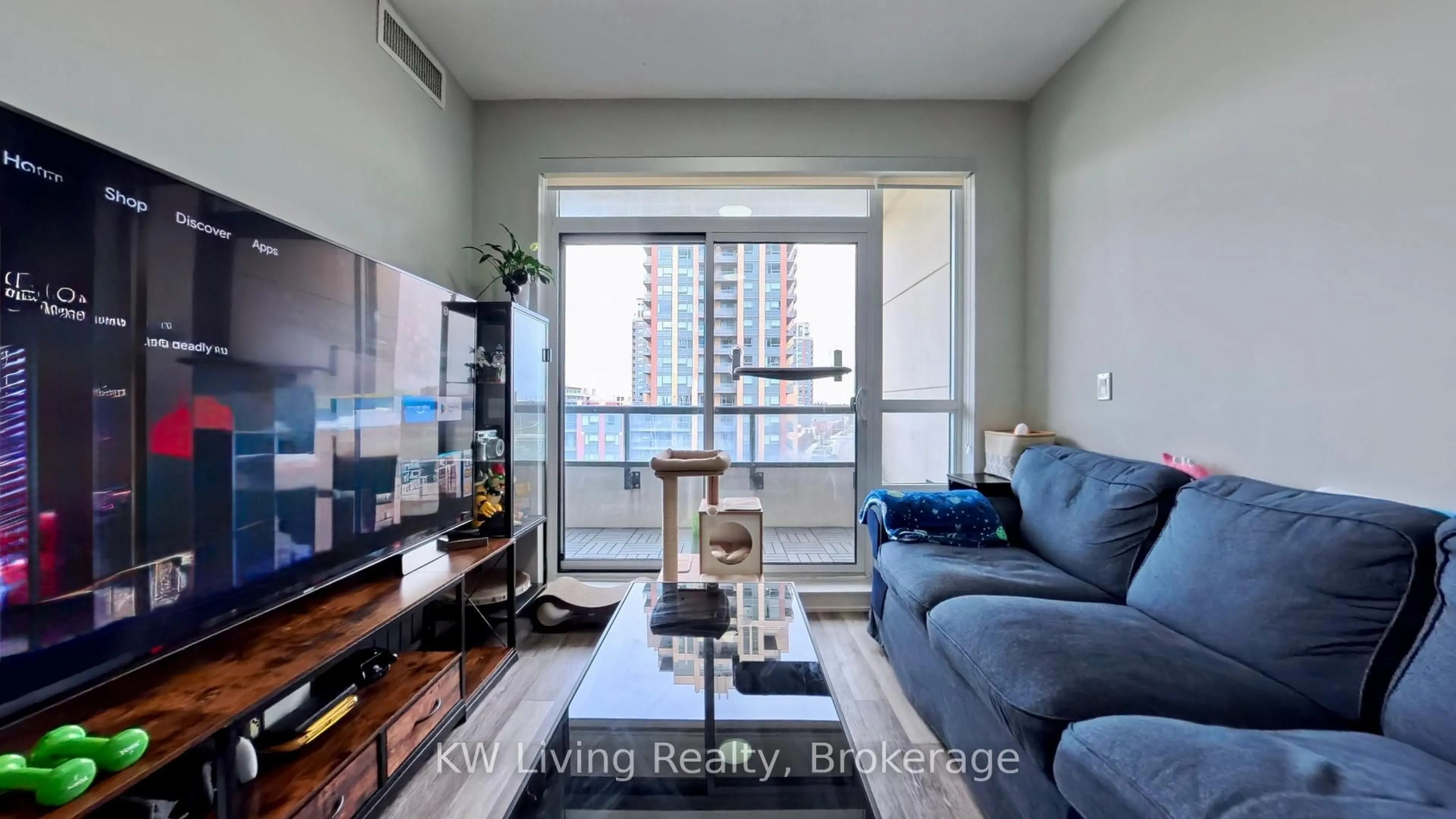 Living room with furniture, wood/laminate floor for 15 Water Walk Dr #711, Markham Ontario L6G 0G2