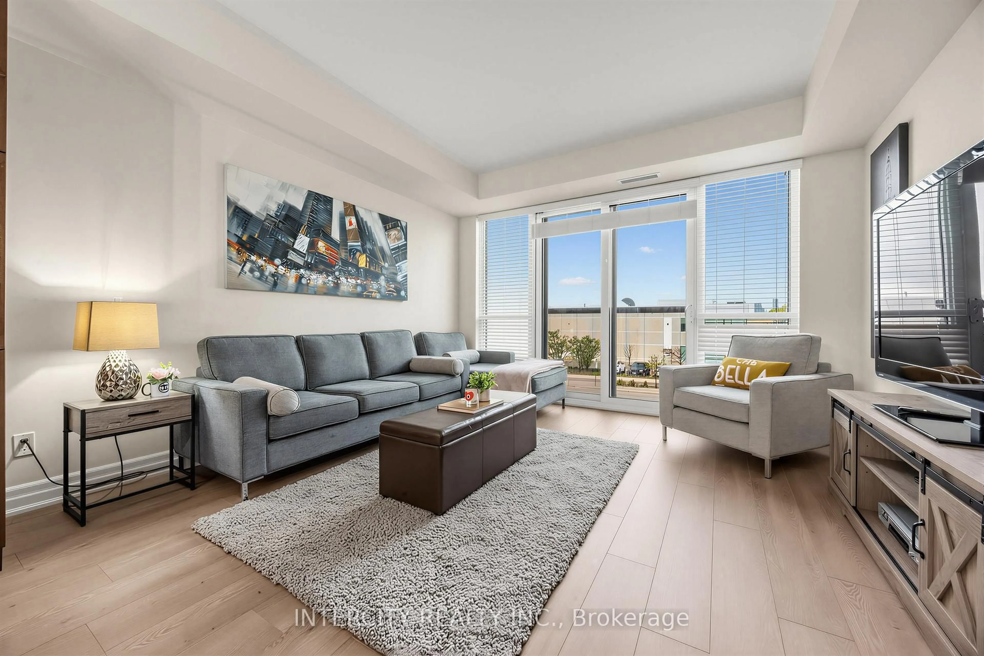 Living room with furniture, wood/laminate floor for 9075 Jane St #210, Vaughan Ontario L4K 0L7
